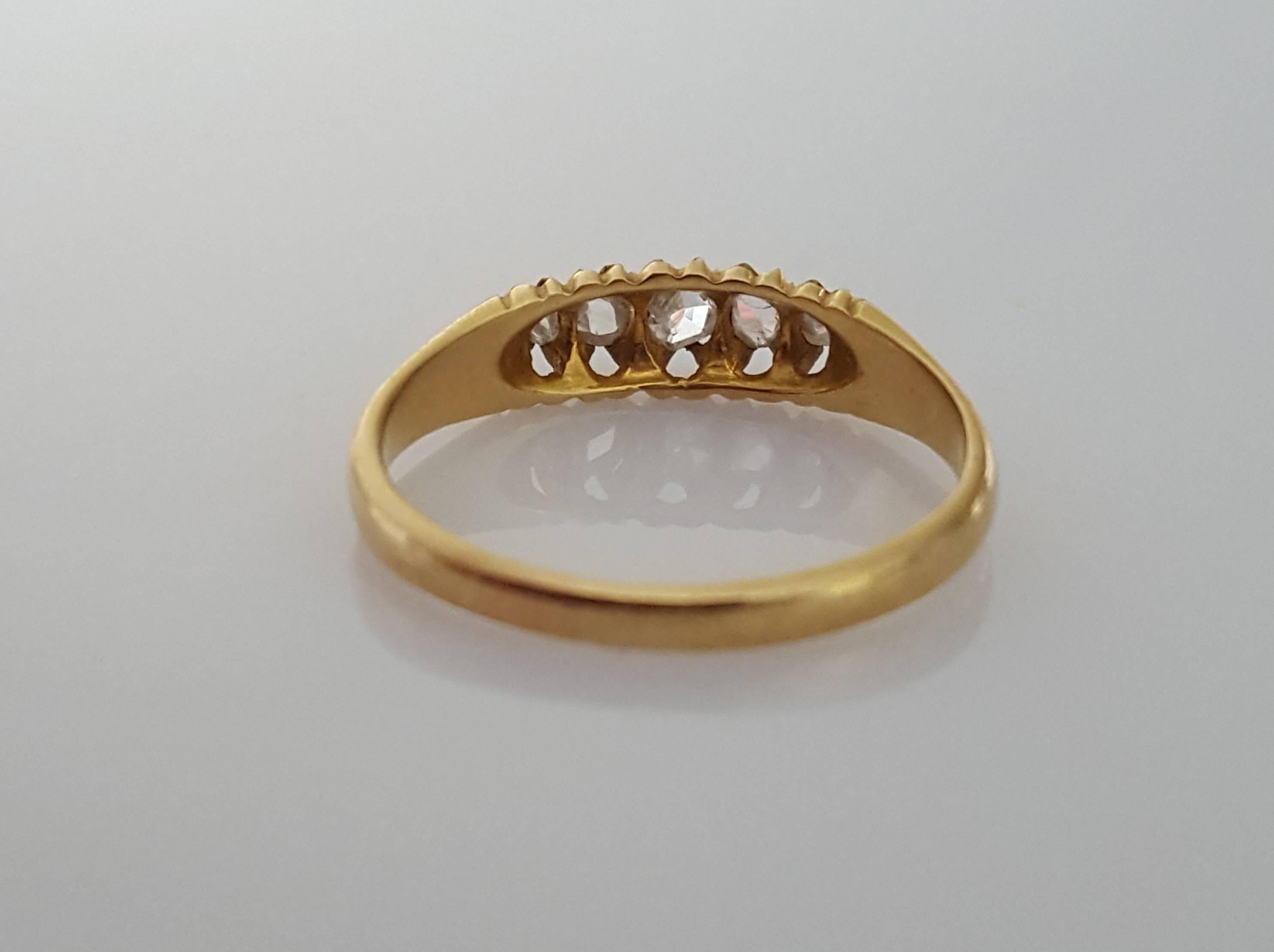 An Antique Edwardian c.1901 18 Carat Gold and five Rose Cut Diamond ring. English origin. 
Size 7.5 US can be sized. 
Height of the face 4mm 
Full English hallmark for 18 Carat Gold. 
Excellent condition for the age. 