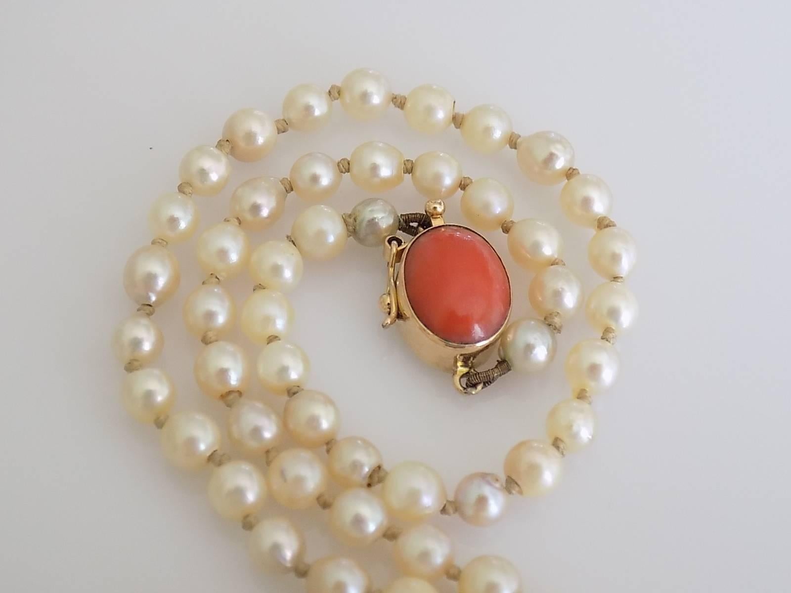 A Lovely Art Deco c.1920s hand knotted Opera length Cultured pearl necklace on 18 Carat Gold and Coral push in clasp.
Length including clasp 30 inch;.
Pearls approx. 4mm.
Weight 16.5gr.
Marked 750 for 18 Carat Gold.
