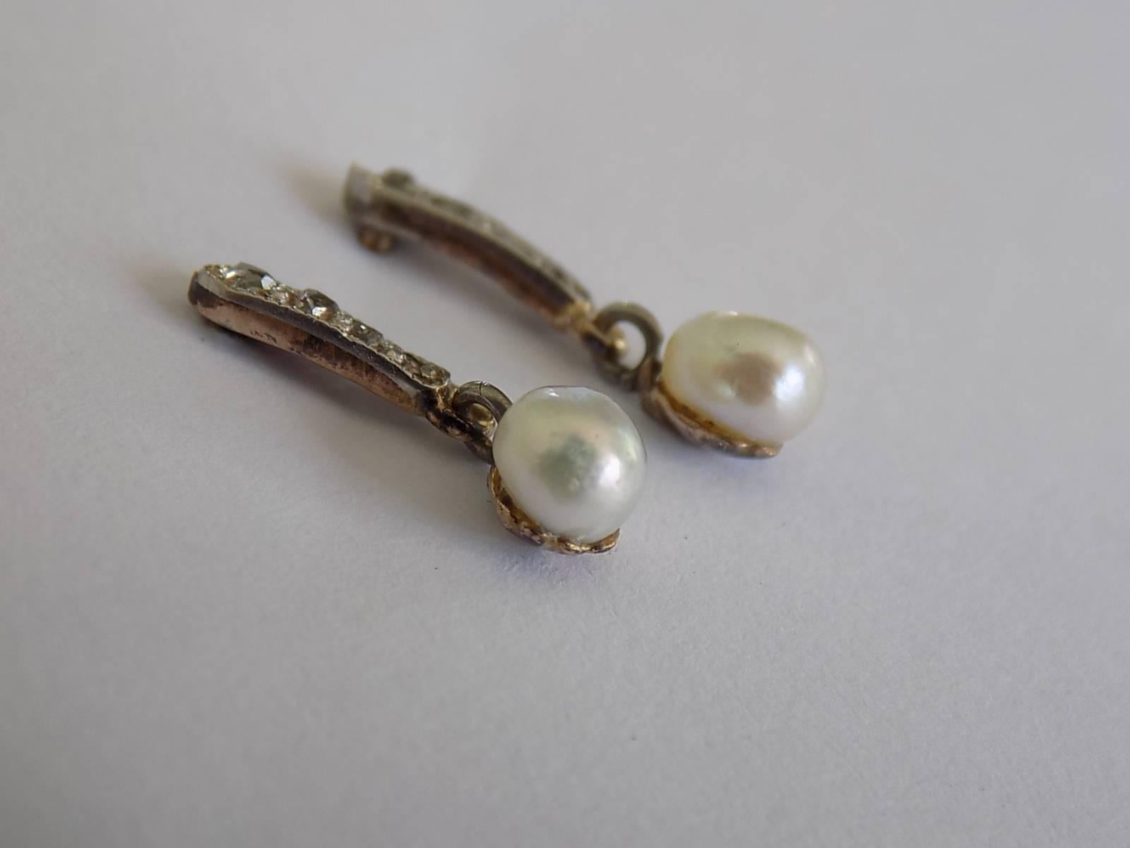 A Lovely Edwardian c.1900 Gold, Rose cut Diamond and Seed Pearl drop earrings. Earrings with a screw posts and backs for pierced ears.
Total drop 15mm.
Width of the pearl 4mm.
Weight 1.2gr.
Unmarked.