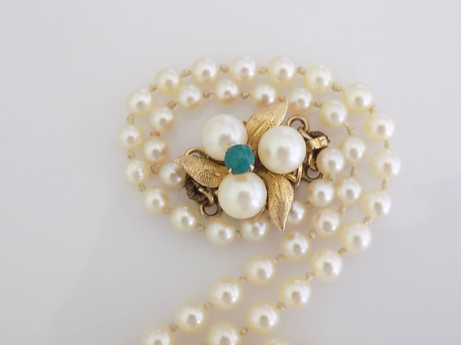A Lovely Vintage 14 Carat Yellow Gold hand knotted Cultured pearl necklace.  The clasp with a Turquoise in the middle surrounded by three Pearls.

Length including clasp 22