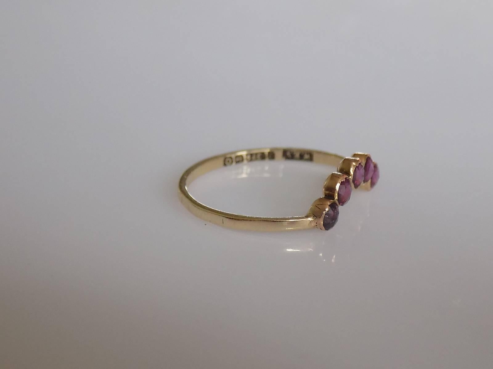 A Lovely Georgian pre-1837 rose cut Garnet hair ornament conversion ring. The Garnets in closed back Gold setting on later 9 Carat Gold shank. Perfect as everyday ring. English origin.
Size P UK, 8 US.
Garnets from 3mm.
Full Birmingham hallmark for