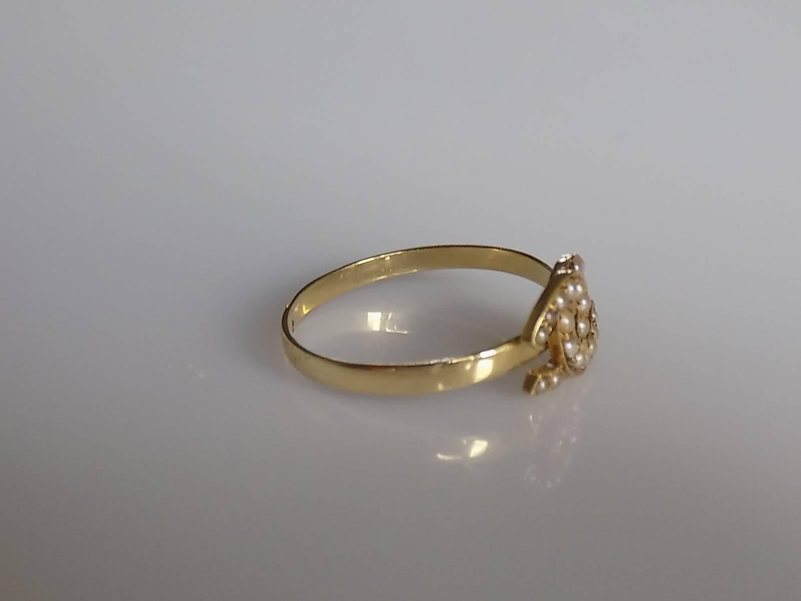 A Lovely Victorian split Seed Pearl double Horseshoe Good Luck stick pin conversion ring on a later 18 Carat Gold shank.  English origin.
Size N 1/2 UK, 7.25 US can be sized.
face of the ring 8mm x 11mm.
Weight 1.6gr.
Unmarked, tested 18 Carat