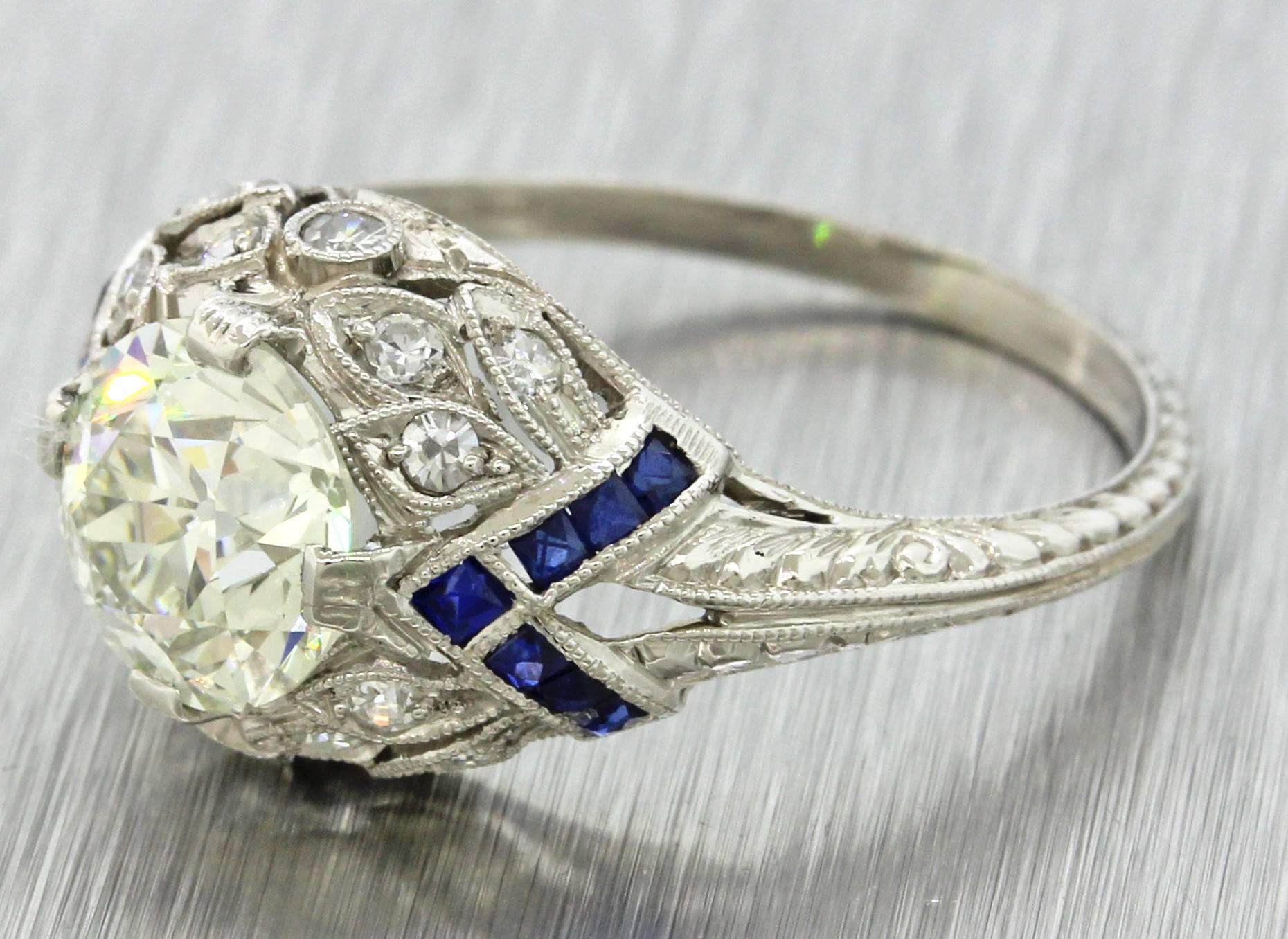 This is an antique Art Deco platinum filigree diamond and sapphire engagement ring that can be dated back to the 1920s. This rings center diamond was graded by world-renowned EGL USA; one of the most reputable diamond grading organizations in the