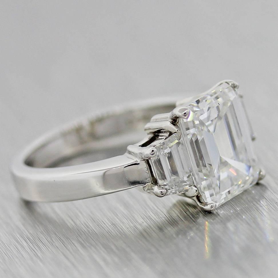 Gorgeous 3.90 carat GIA Emerald Cut Diamond Platinum 3 Stone Engagement Ring In New Condition For Sale In Huntington, NY