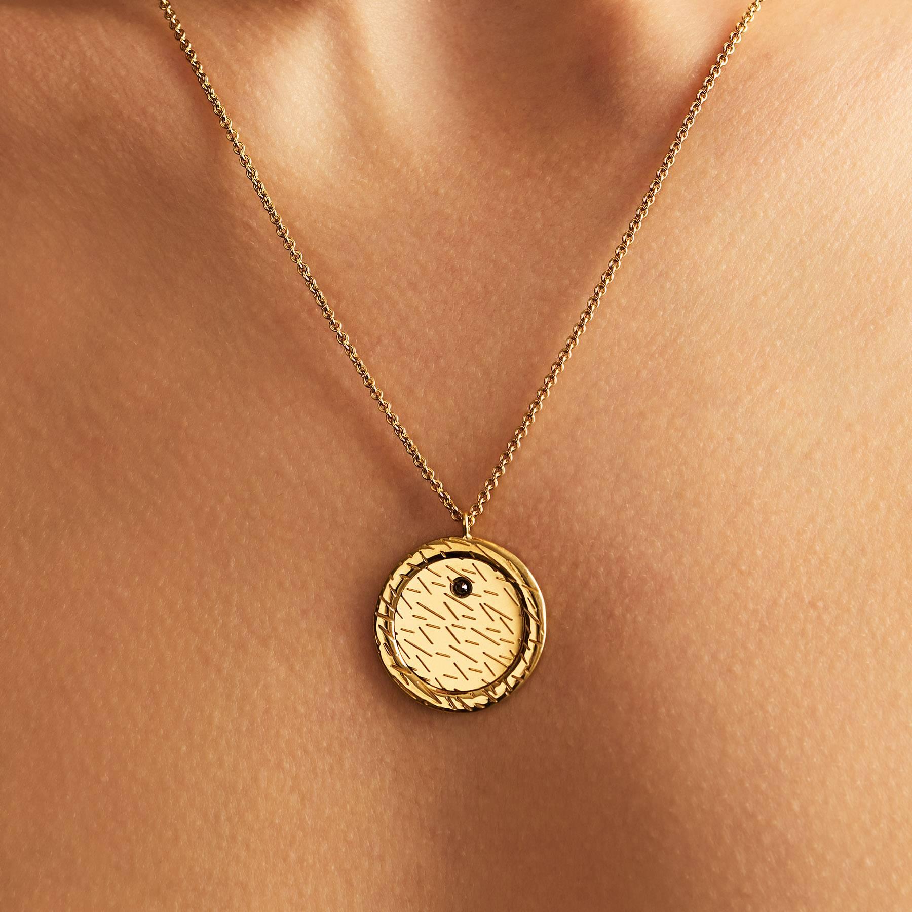 18ct yellow gold pendant necklace with fur texture engraving and 0.04ct black diamond
Fully adjustable length chain; sizes 18” and 22”* available
Circle diameter measuring 21mm
Made in London

The statement black diamond pendant features our