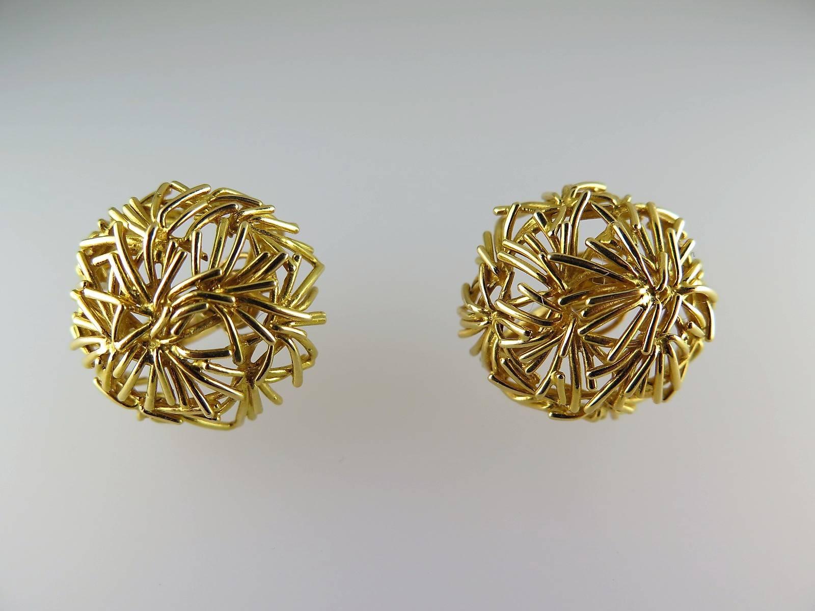 Each gold pierced bombé earclip of inverted bird's nest design signed by Boucheron Paris, numbered, French assay marks