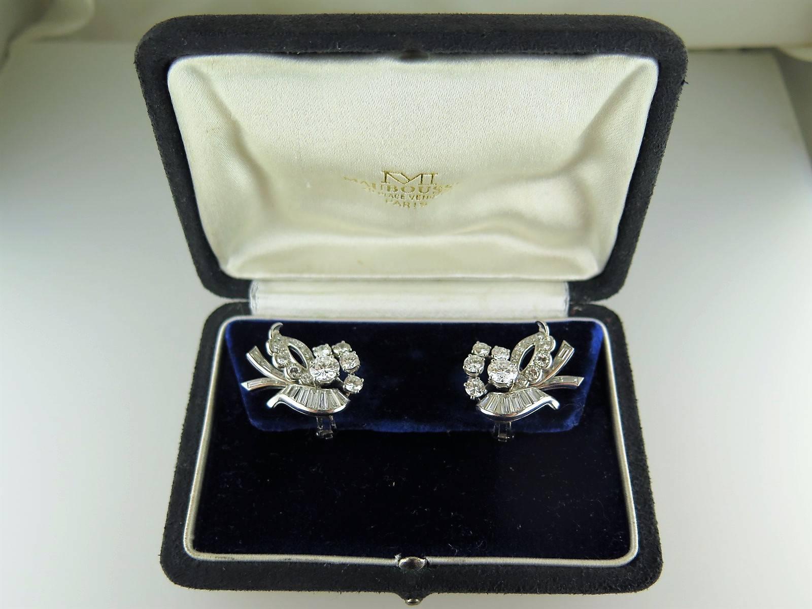 Each brilliant and baguette-cut diamond earclip of floral bouquet design mounted in platinum and gold, signed Mauboussin, numbered 1304, French marks, in fitted case, estimated total diamond weight approximately 6.00cts 