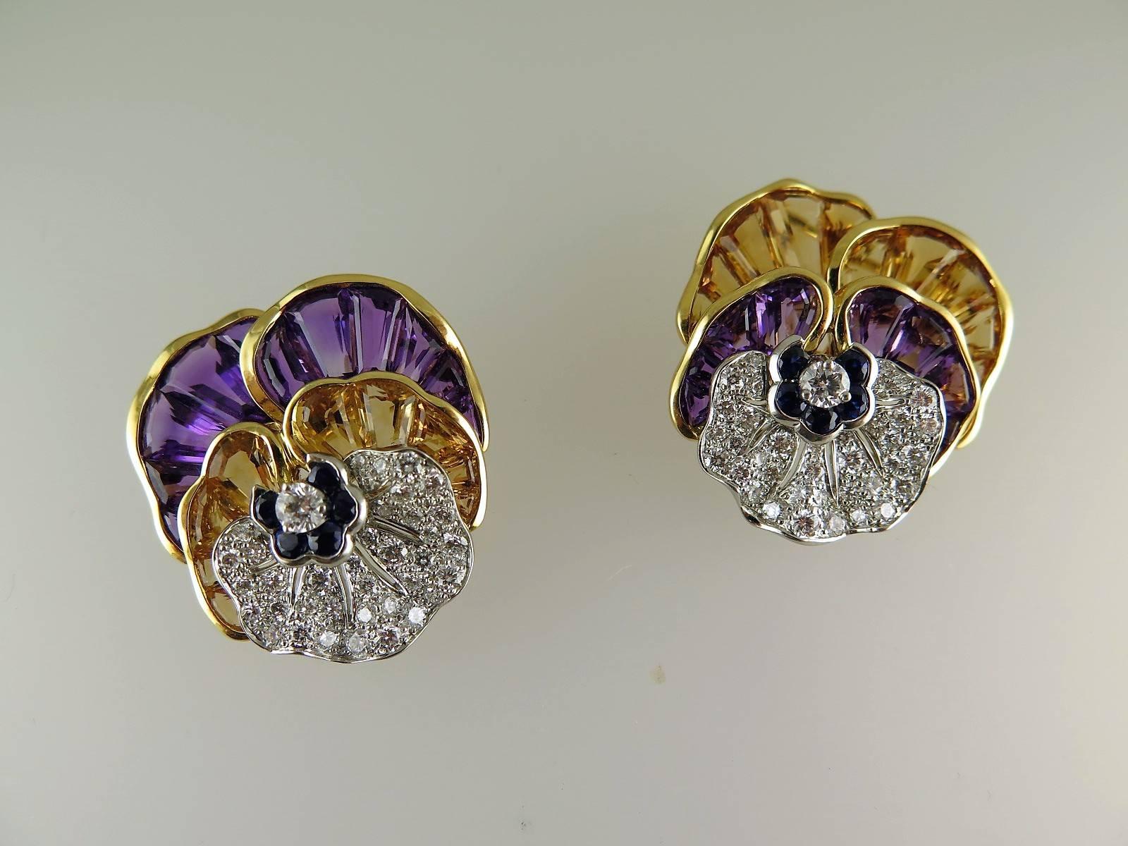 The petals set with channel-set calibre-cut amethyst and citrines and pavé-set brilliant-cut diamonds to the single brilliant-cut diamond centre with circular-cut sapphire detail, mounted in 18ct gold, numbered, makers mark. These are particularly