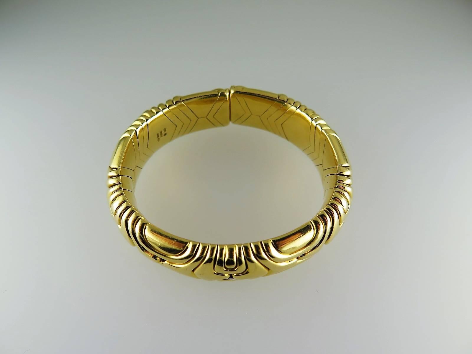 The polished 18ct gold sprung bangle of modular design, Signed Bulgari, Italian assay marks, dated 1989 
