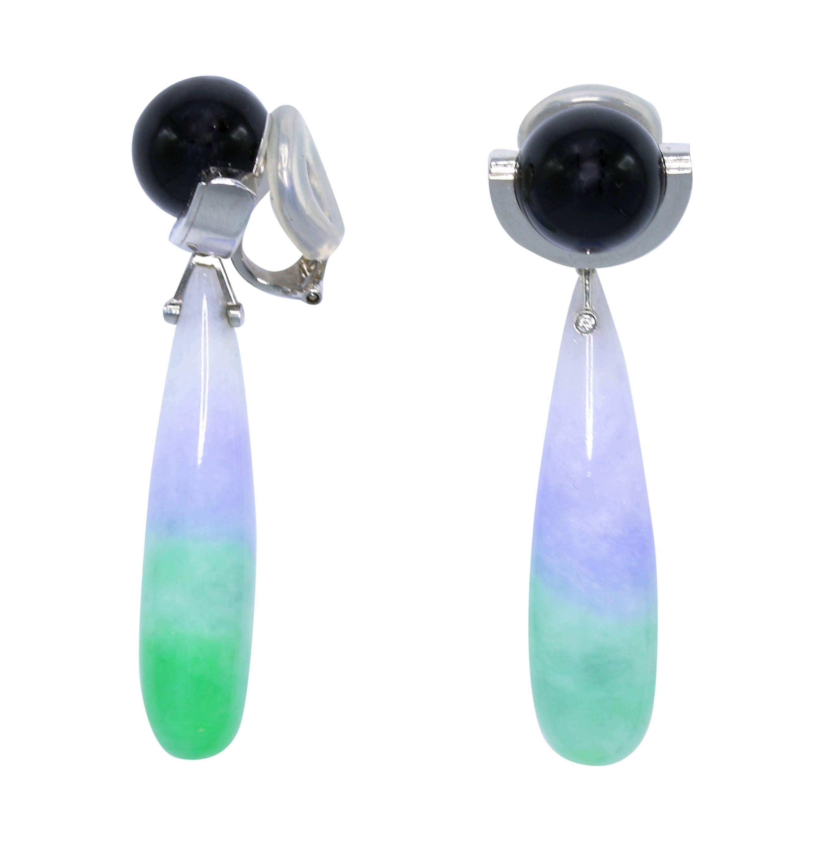 A pair of rare Art Deco Onyx and two-tone jadeite jade drop-dangling ear clips. The handmade work is styled in 18-karat white gold. The jade drops are a natural color with no indication of treatment or dye. The drops are adorned with a small