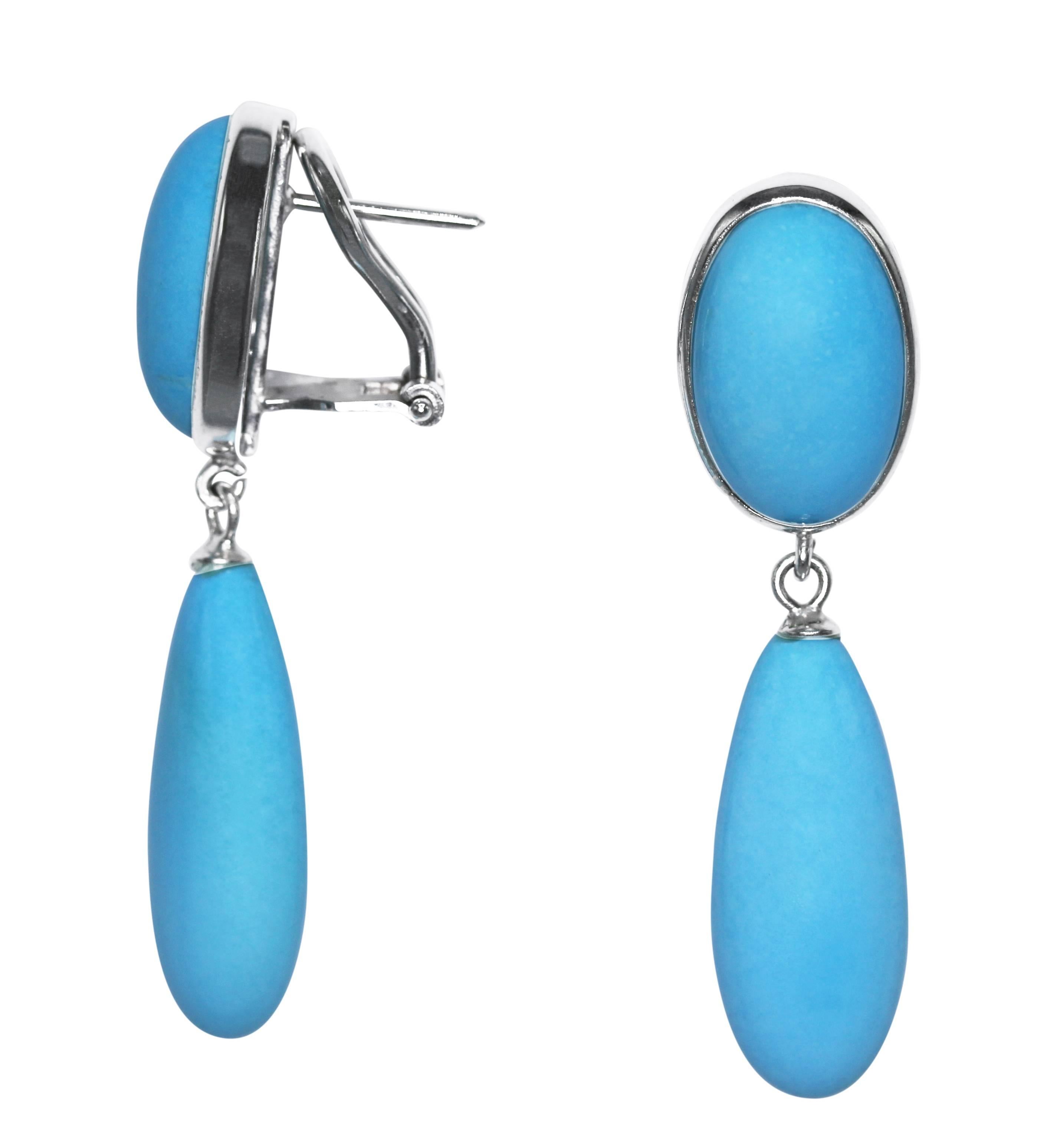Pair of natural turquoise and 18 karat white gold earlcips, designed with oval tops set with oval cabochon turquoise segments, supporting articulated drops of turquoise, gross weight 12.6 grams, measuring 1 3/4 by 1/2 inches, with Italian gold