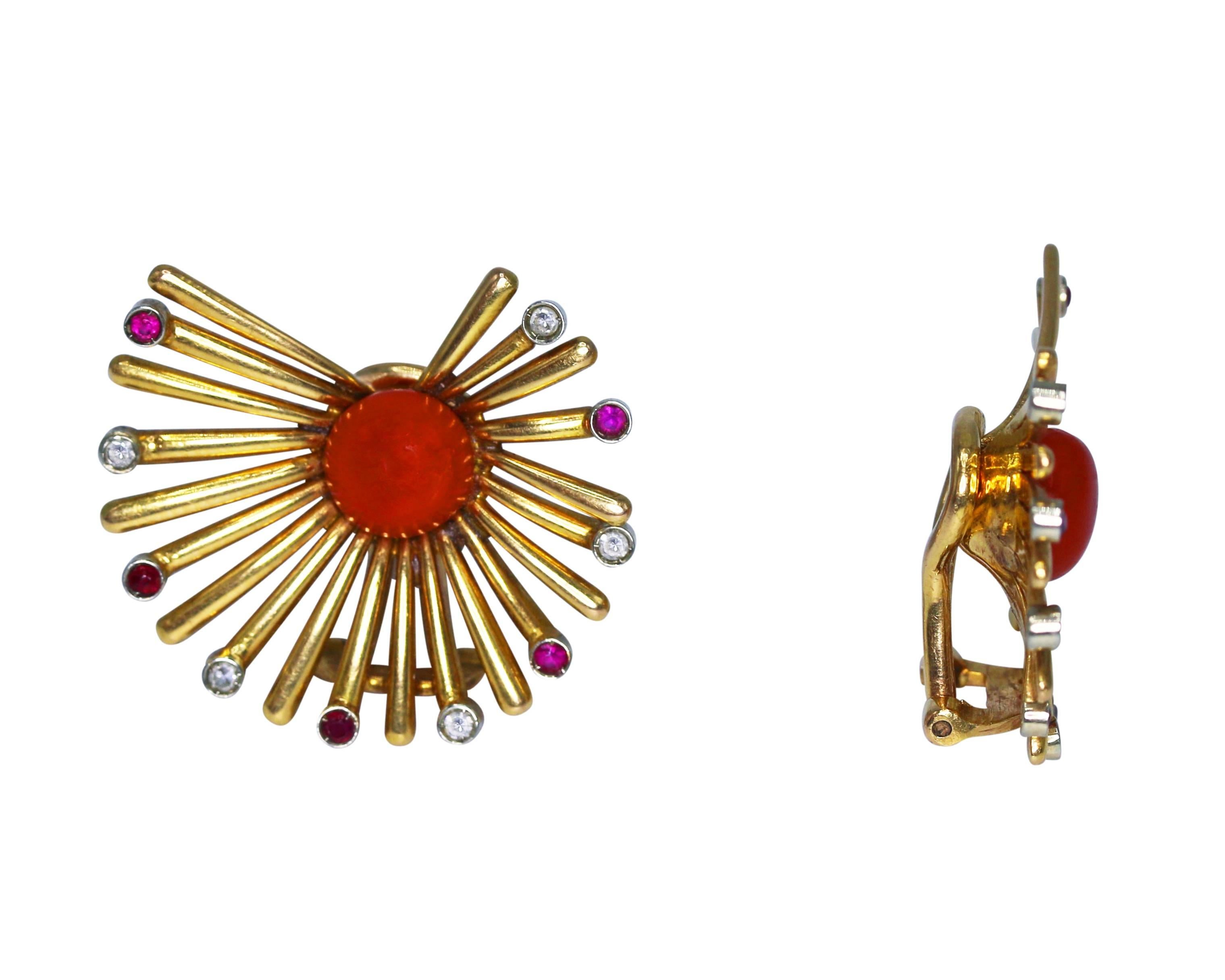 Fantastic earclips from the 1950s designed as fans with coral cabochon centers of rich red color, accented by polished gold tendrils alternately set with small round diamonds and rubies, gross weight 11.0 grams, measuring 1 1/8 by 1 inches, mounted