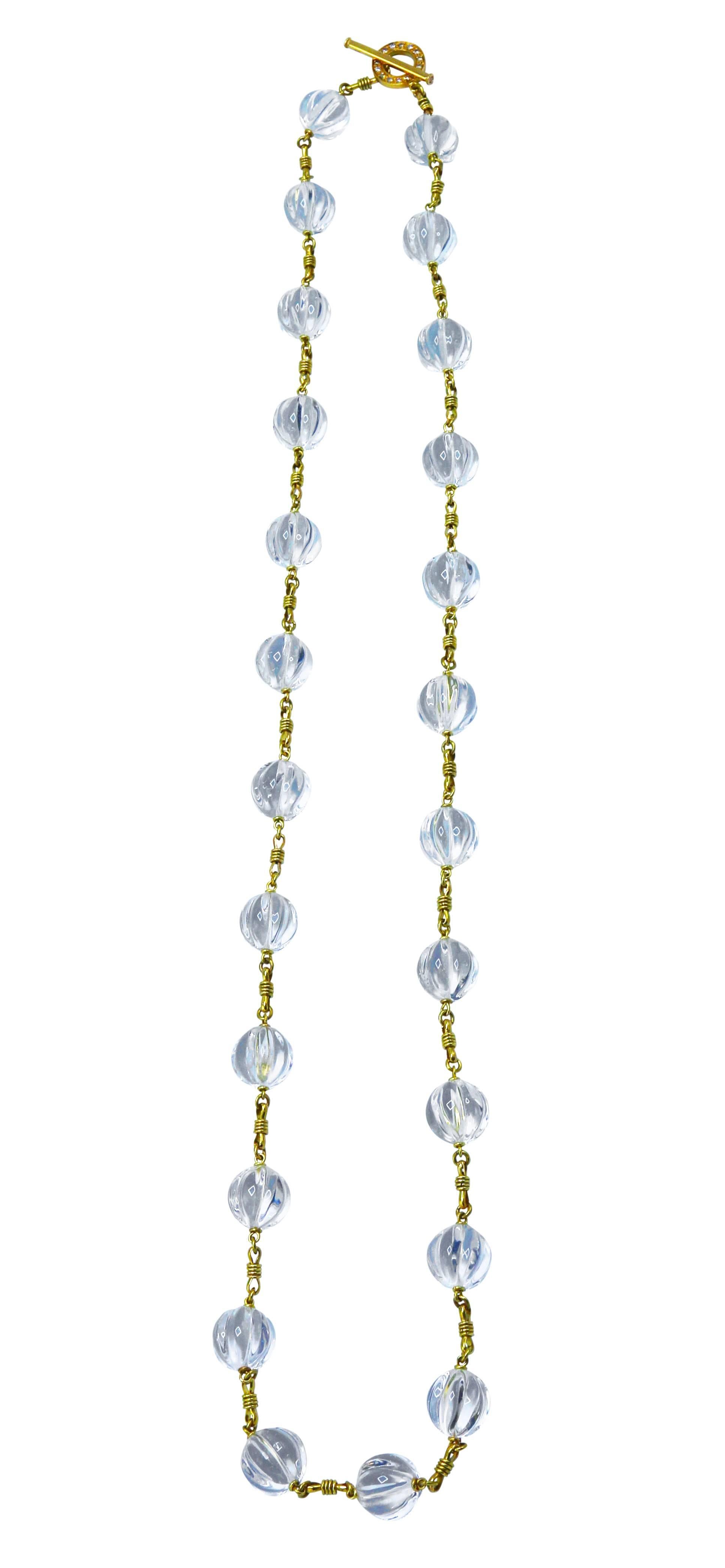 Wonderful handmade rock crystal, diamond and 18 karat gold necklace, composed of a series of carved rock crystal beads, alternating with hand-twisted gold links, completed by a circular clasp set with round diamonds weighing approximately 0.40