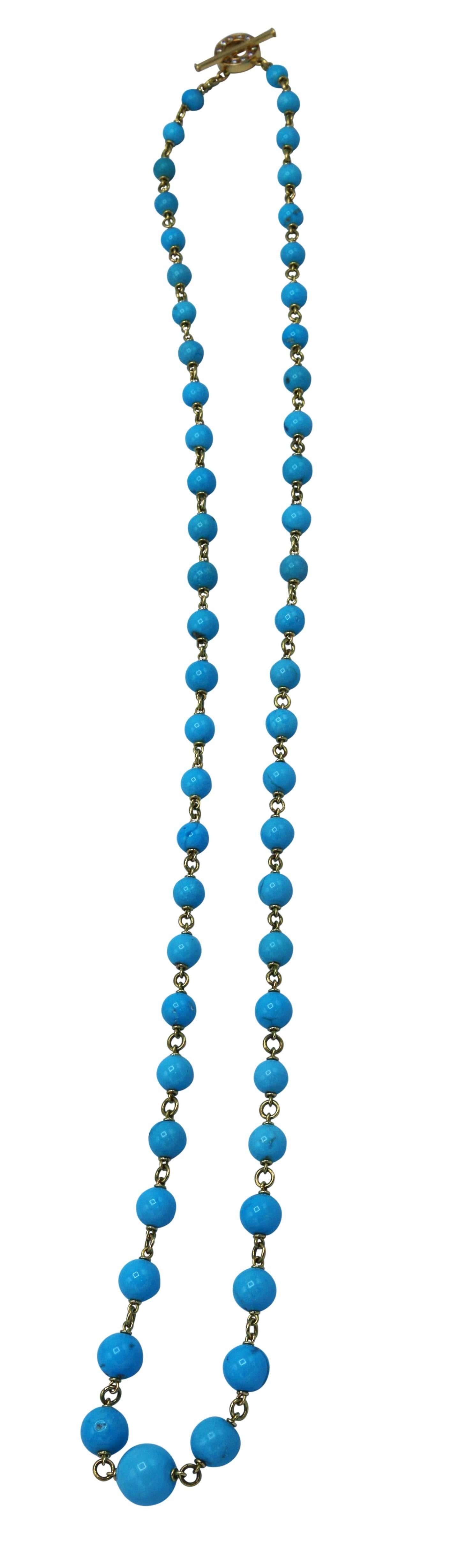 18 karat yellow gold, turquoise and diamond necklace, designed as a graduated strand of natural Sleeping Beauty turquoise beads measuring approximately 7.0 to 15.0 mm., the circular clasp set with round diamonds weighing approximately 0.35 carat,