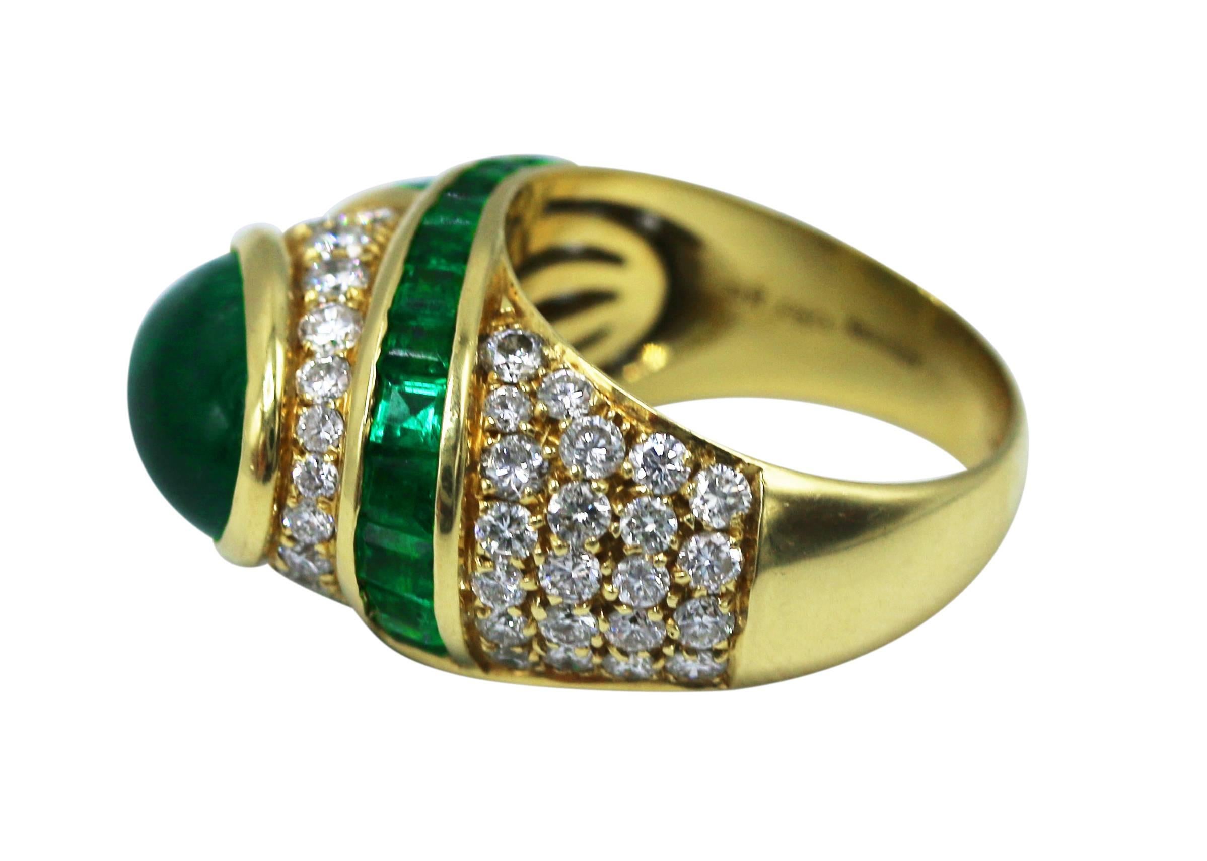 Superb 18 karat yellow gold, emerald and diamond ring by Chaumet, Paris, set in the center with a cabochon emerald, framed by sections of calibre-cut emeralds, and round diamonds weighing approximately 1.70 carats, the total emerald weight 6.00