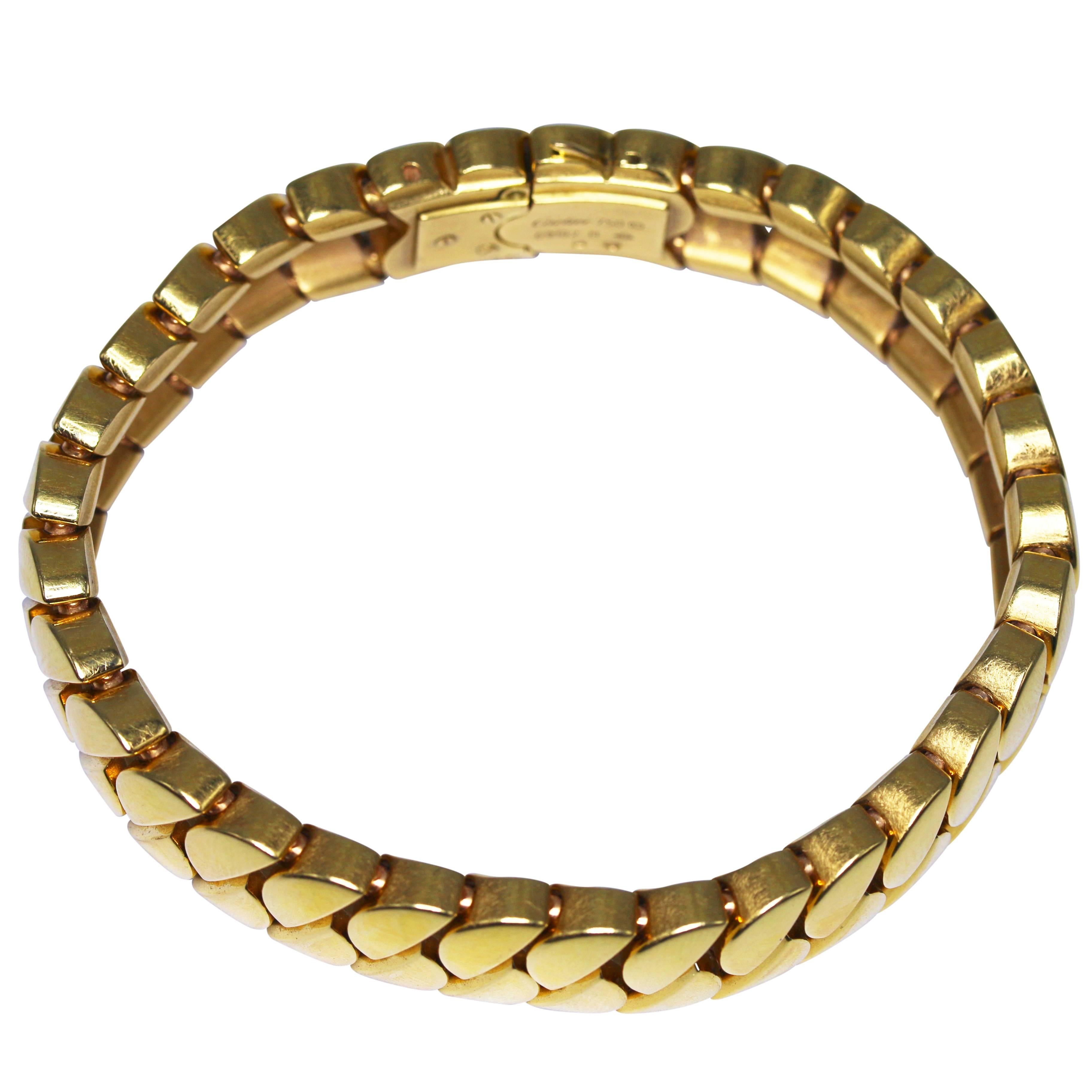 A classic 18 karat gold link 'La Dona' bracelet by Cartier, designed as a series of polished gold half moon shaped links in an angled double row, gross weight 106.0 grams, length 7 inches, width 5/8 inch, signed Cartier, numbered 69182 B, with