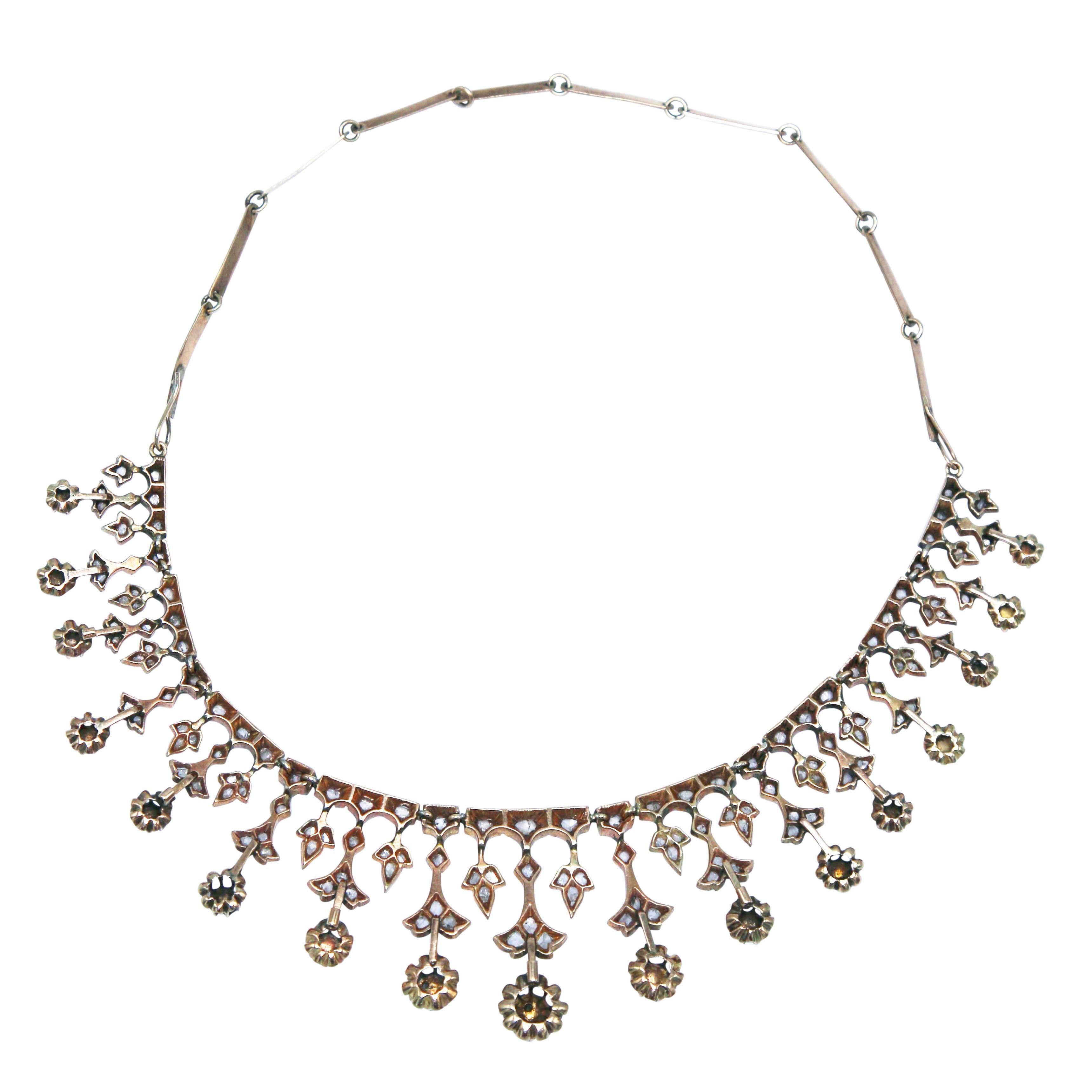 A rare mid 19th century gold and diamond fringe necklace, the graduated fringe of floral and foliate design set throughout with numerous rose-cut diamonds weighing approximately 4.50 carats, completed by a handmade wide link chain attachment at the