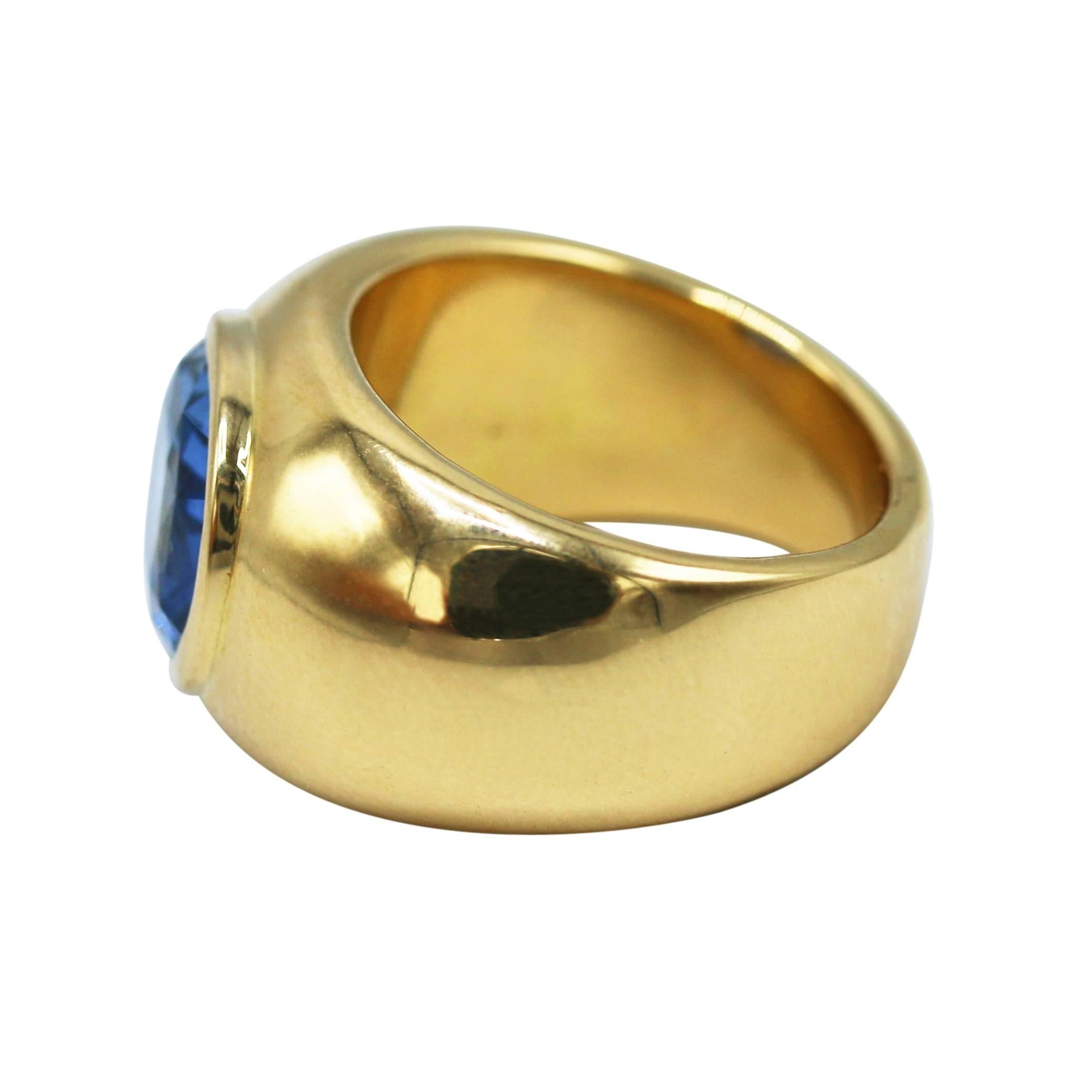 18 karat yellow gold and sapphire ring, the slightly tapered wide band bezel-set with an oval sapphire weighing 8.23 carats, gross weight 20.3 grams, size 7, measuring 1 by 1 by 1/2 inches. The sapphire is accompanied by an AGL report stating that