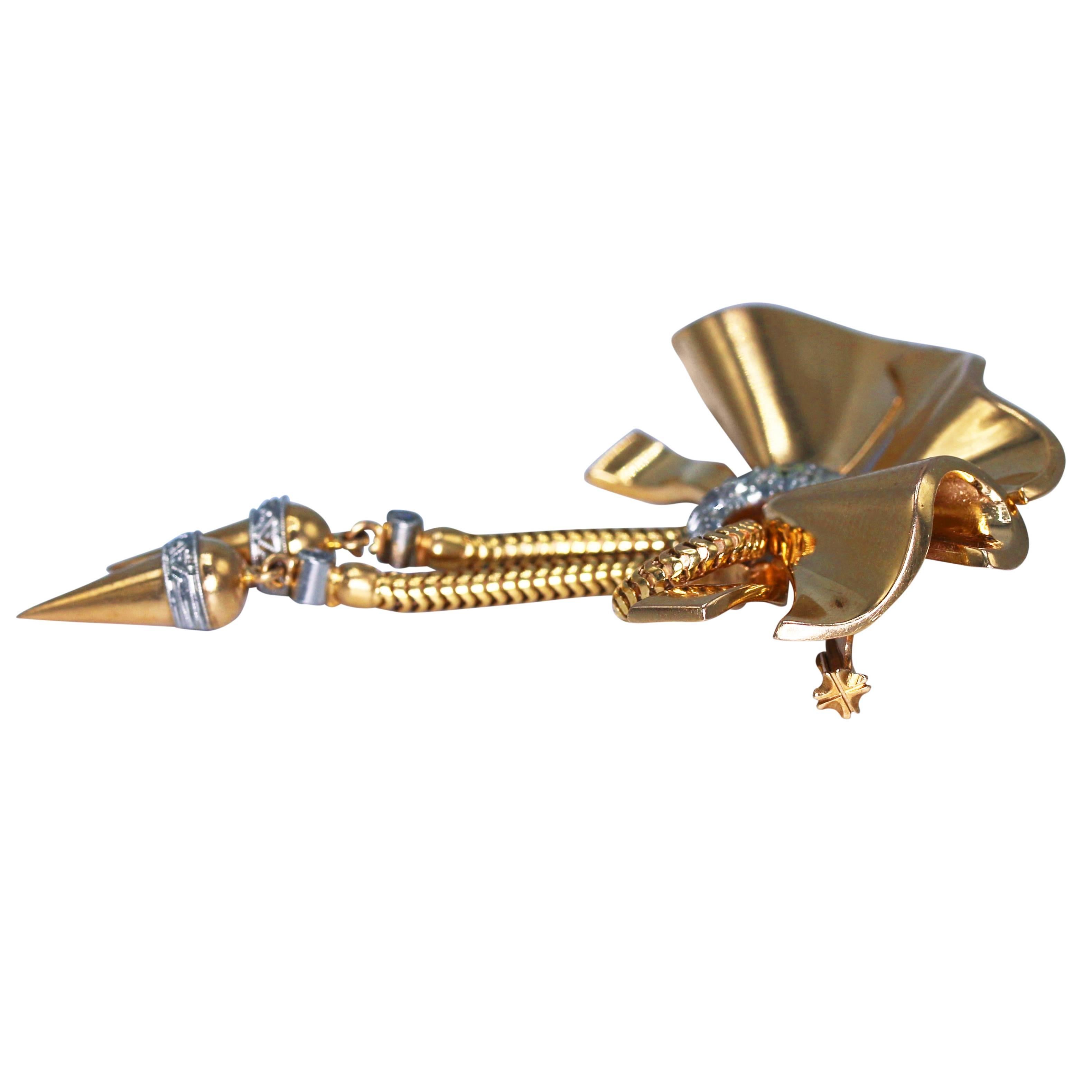 Retro 15 karat rose gold and diamond brooch, circa 1940, designed as an ornate bow supporting two articulated pendants, accented by single-cut diamonds weighing approximately 0.20 carat, gross weight 13.3 grams, measuring 2 5/8 by 1 3/4 inches. Such