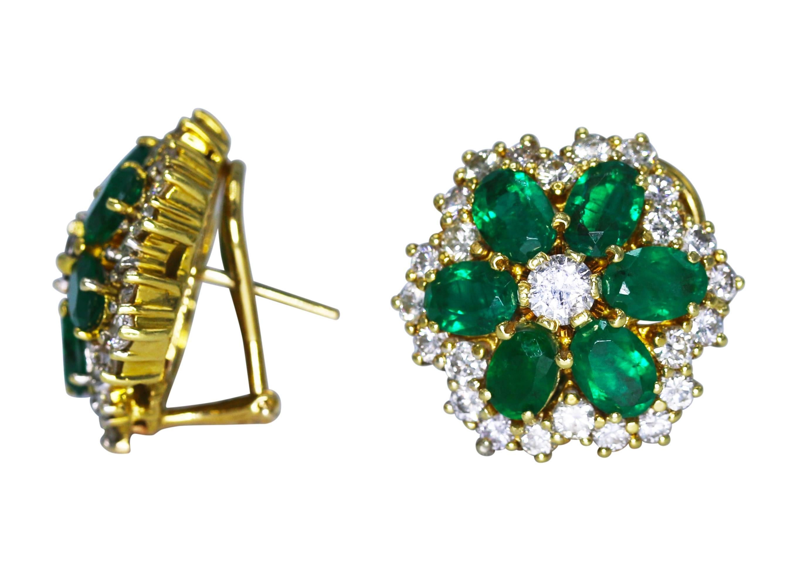Pair of 18 karat yellow gold, emerald and diamond earclips, designed as flowerheads set with emeralds weighing approximately 7.00 carats, accented by diamonds weighing approximately 3.60 carats, gross weight 18.5 grams, measuring 7/8 by 7/8 inch.