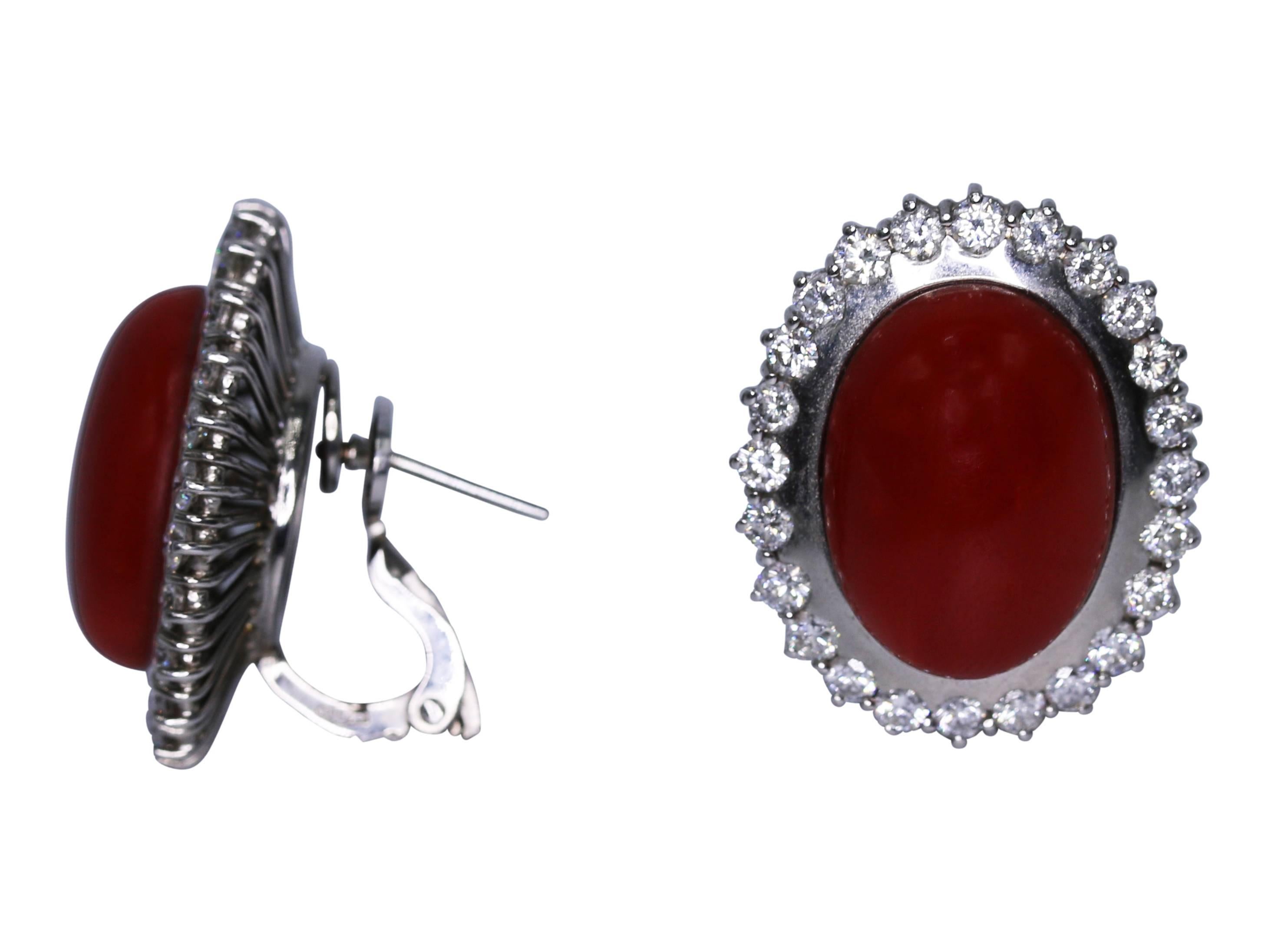 Pair of 18 karat white gold, natural Japanese coral and diamond earclips, set in the center with 2 cabochon untreated natural Japanese coral segments of very dark red color, framed by round diamonds weighing approximately 1.90 carats, gross weight