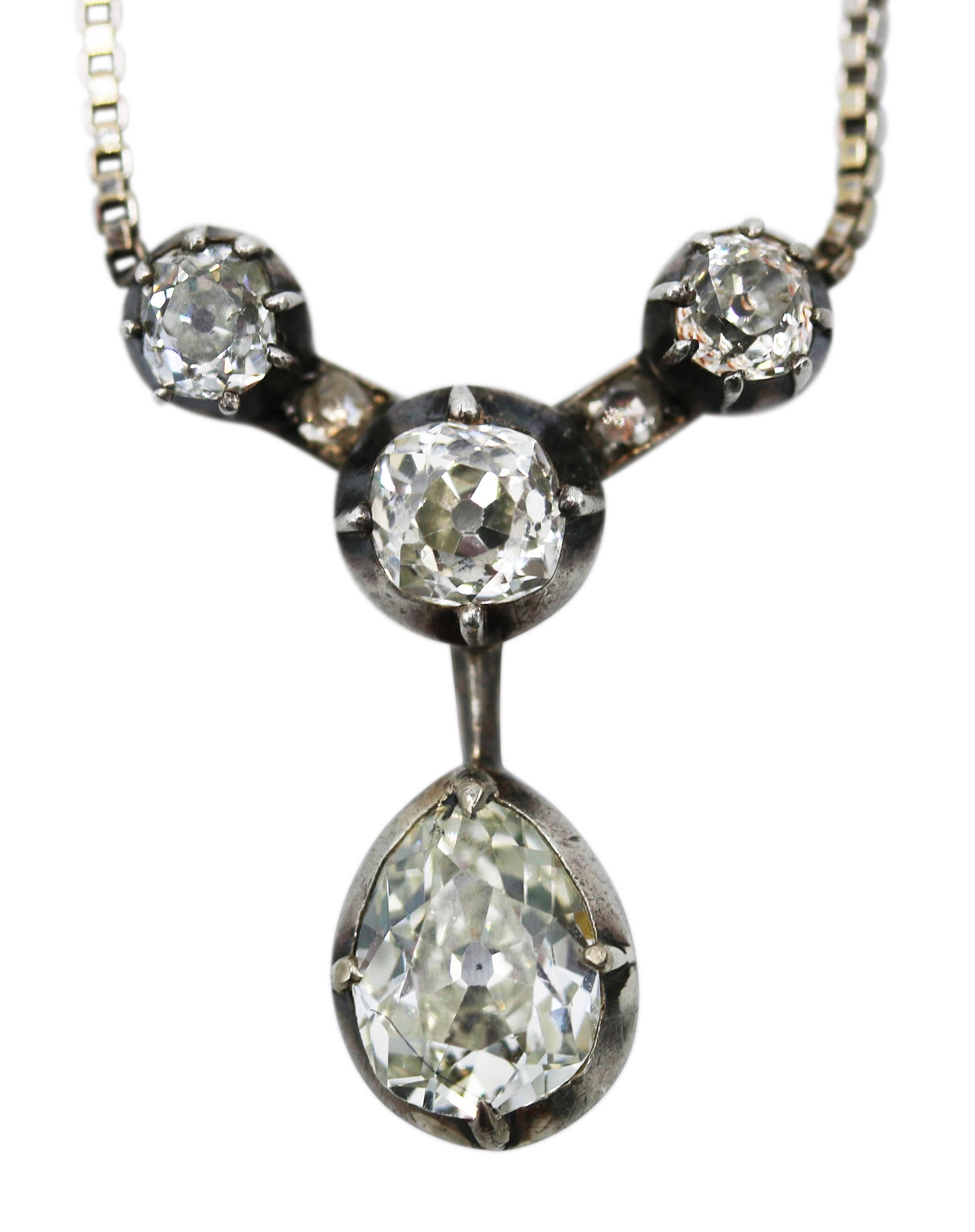 18 karat white gold, silver and diamond pendant necklace, the pendant an antique element of oxidized silver set with pear-shaped and old mine-cut diamonds weighing approximately 3.00 carats, the white gold chain later added, gross weight 7.4 grams,