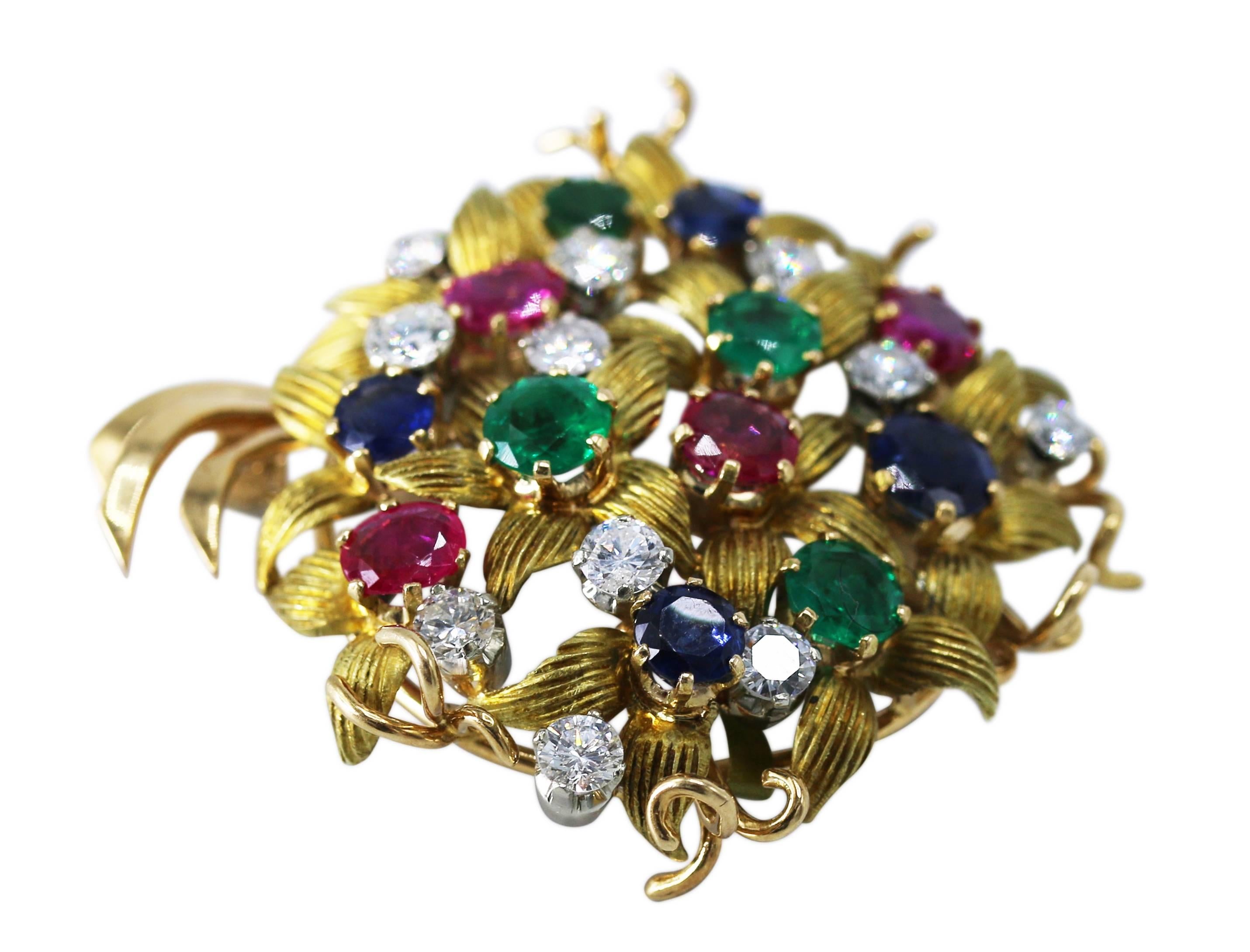 18 karat two-tone gold, sapphire, emerald, ruby, and diamond bouquet brooch, designed as a floral bouquet of round sapphires, round emeralds, round rubies and round diamonds, accented by textured gold leaves, total diamond weight 1.50 carats, gross