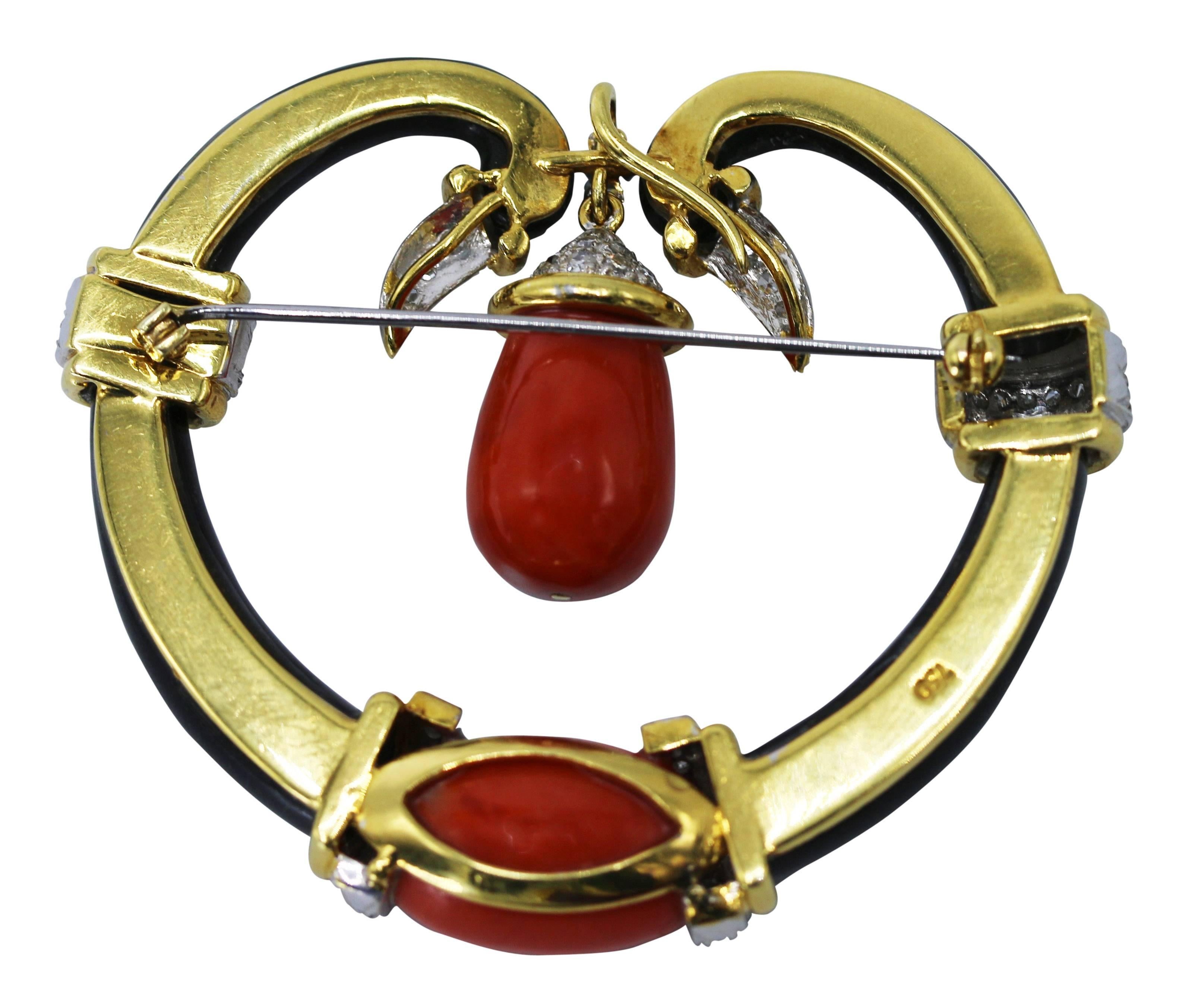 18 karat yellow gold, coral, onyx and diamond brooch, of openwork design composed of a carved onyx scroll accented by carved coral segments, set throughout with round and single-cut diamonds weighing approximately 1.40 carats, gross weight 41.3