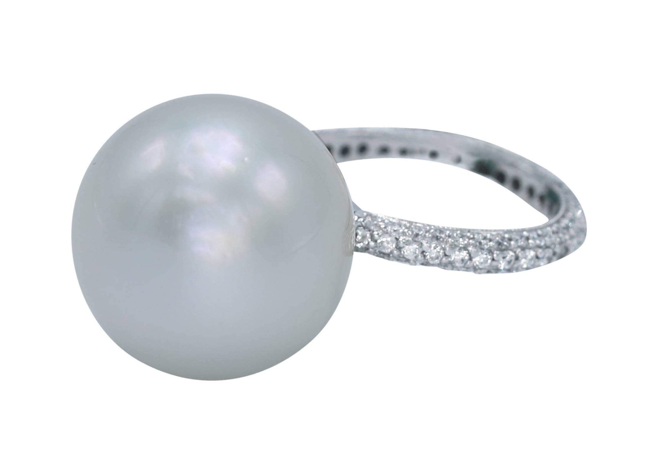A simple yet elegant south sea pearl and diamond cocktail ring, set with a large south sea cultured pearl measuring 18.0 mm., the shank set throughout with numerous round diamonds weighing approximately 1.50 carats, mounted in 18 karat white gold,