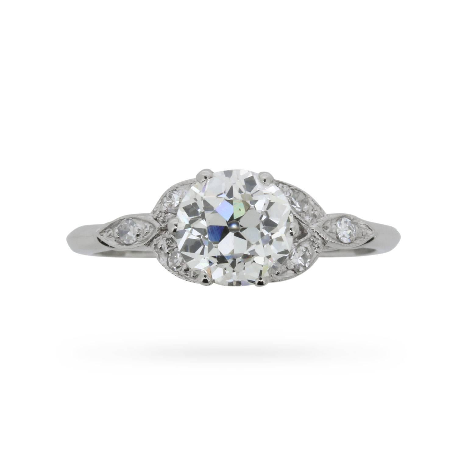 An elegant platinum and diamond engagement ring dating from the 1940s and featuring a gorgeous EDR certified 1.24 carat old cut diamond.

Grain-set eight cut diamonds add an extra splash of sparkle to the setting of this already lively solitaire,