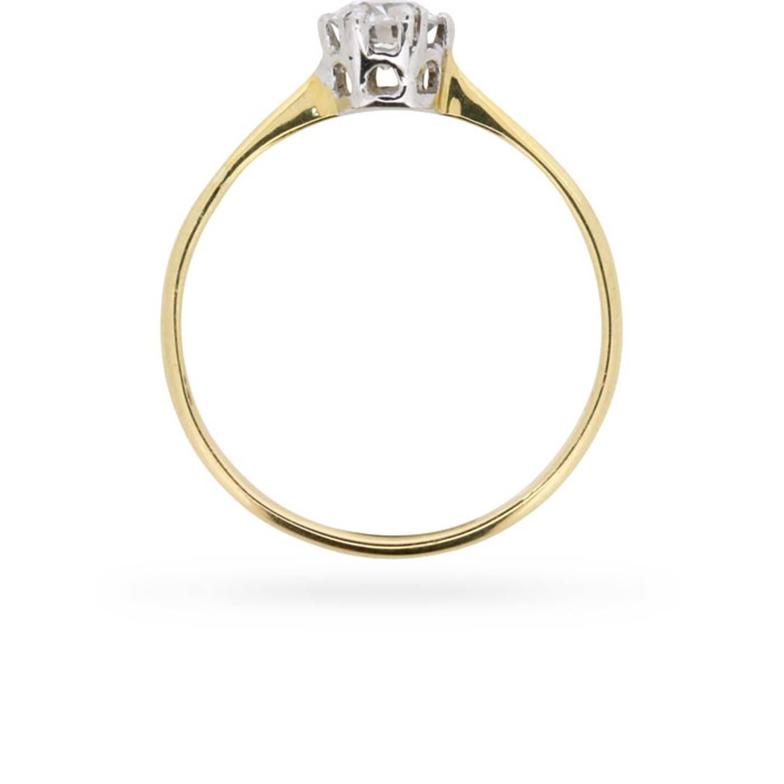 An old cut diamond weighing 0.50 carats is simply and elegantly presented in its original two-tone platinum and 18 carat gold setting at the centre of this late Victorian era engagement ring.

This lovely antique stone has been graded to a desirable