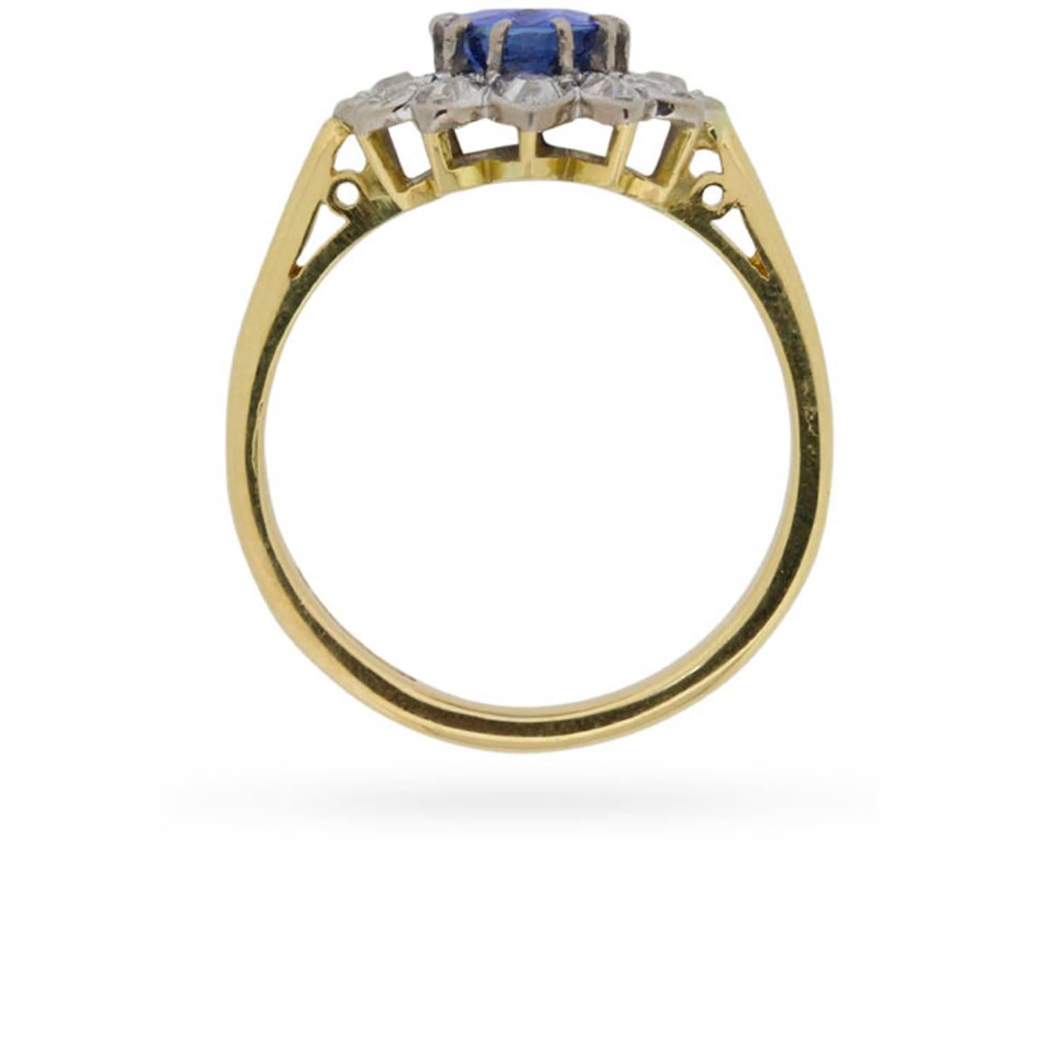 Flower cluster rings have been a perennial favourite since Victorian times, but this circa 1940s rendition is one of the prettiest and most unique examples that we’ve seen.

A bright blue, 1.50 carat, oval-shaped sapphire is the centre to twelve old