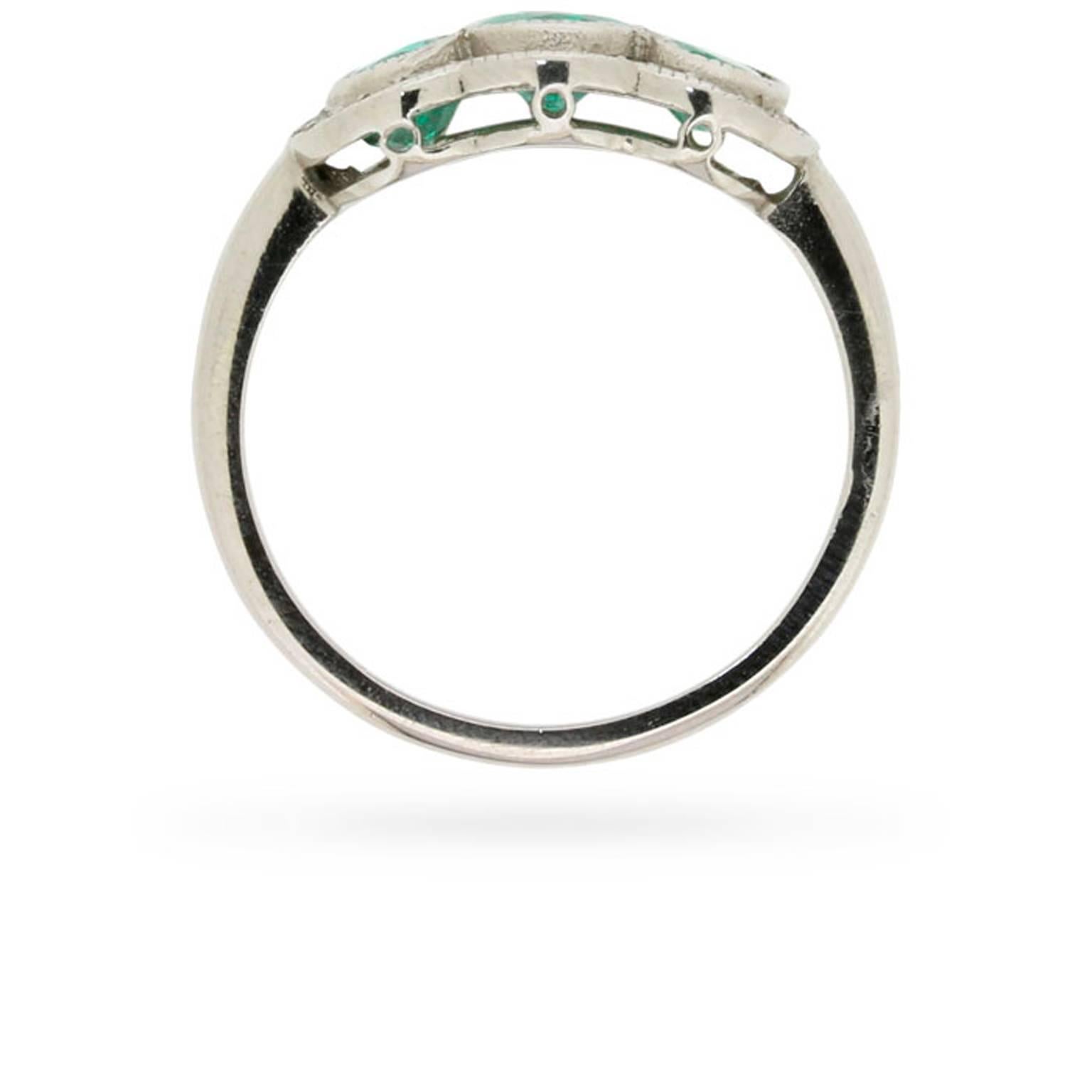 This vintage mid-century emerald and diamond ring has a soul much older than its years.

Dating from the 1950s, this ring features a resplendent trio of natural, oval-shaped emeralds in a verdant shade of green.

A grain set border of 0.30ct eight