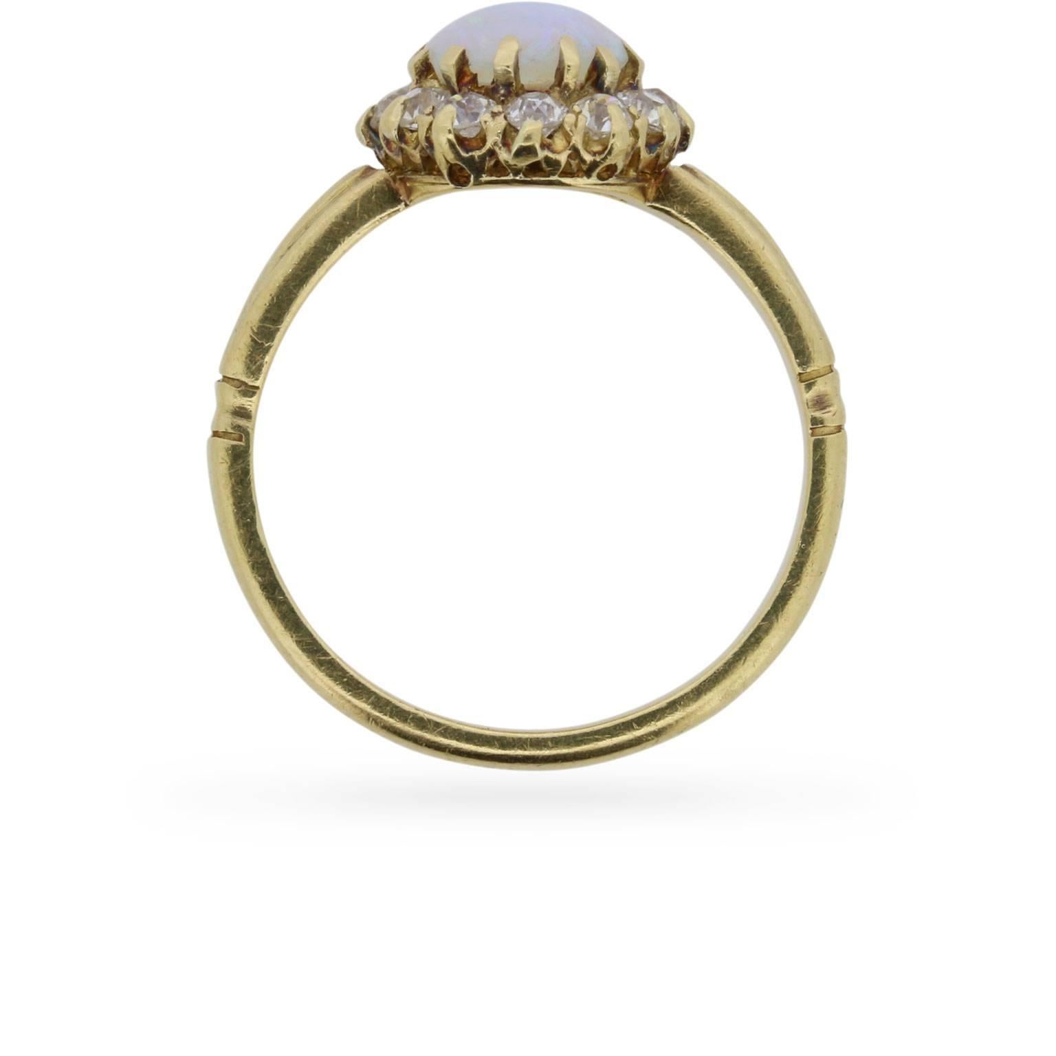 This original Victorian era opal and diamond cluster ring centres a dreamy opal cabochon within a sparkling halo of old cut diamonds.

Its antique 18 carat yellow gold setting was handcrafted in the coronet style during the 1880s with fluted