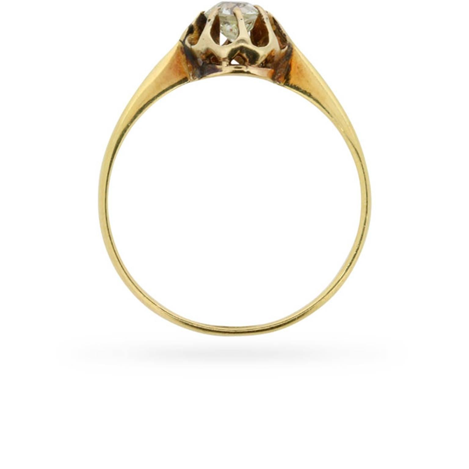 Eight curving claws secure an old cut diamond within its original mounting at the centre of this 18 carat yellow gold engagement ring. This unmistakably handmade antique engagement ring dates from 1905.

Gemstone: Diamond
Stone Shape: Old Cut
Carat