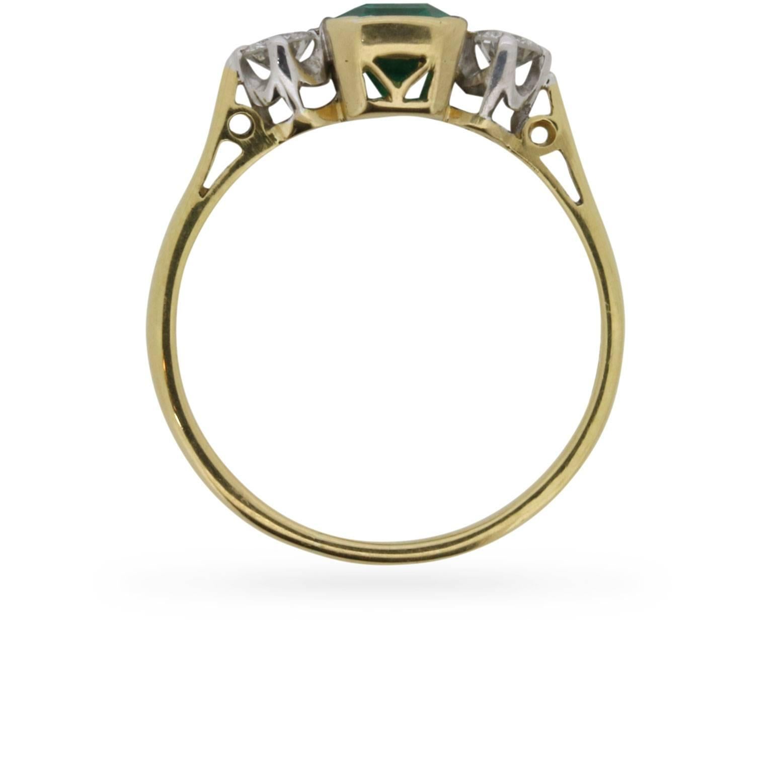 This beautiful three stone Emerald ring is a gorgeous example of a 1980s engagement ring. The 1.40 carat Emerald is accompanied either side by claw set, round brilliant diamonds.

The diamonds are set with platinum claws, and the Emerald with a