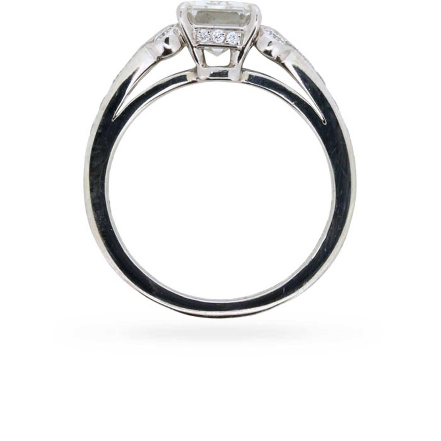 A 1.51 carat emerald cut diamond of exquisite quality is lavishly presented in the world-renowned French jeweller Cartier's 'Paved Ballerine' setting at the centre of this distinctive engagement ring. The ring's opulent platinum setting is grain set