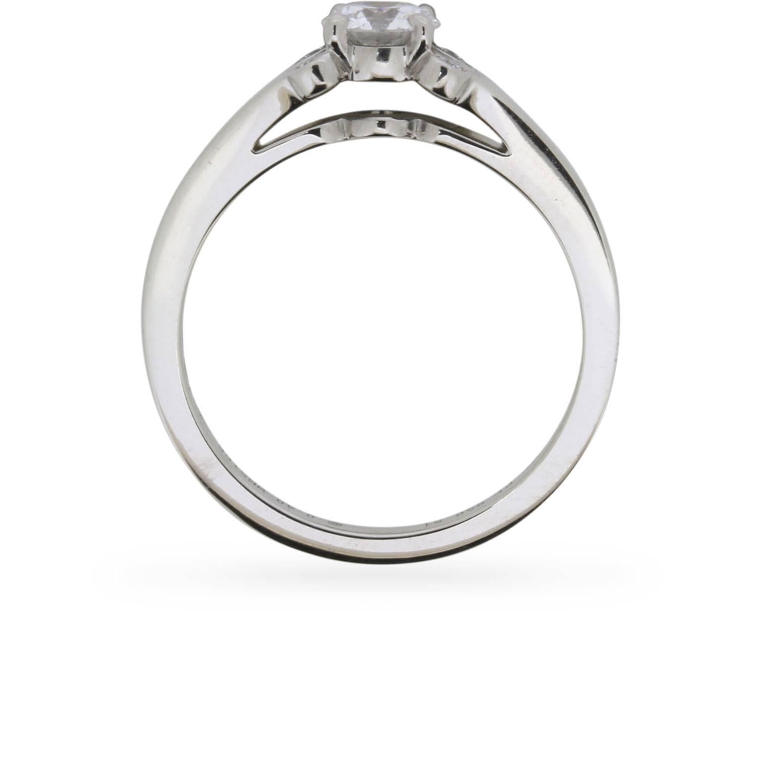 Elegant and understated, this Cartier ‘Ballerine’ solitaire engagement ring presents a 0.40 carat round brilliant cut diamond at the centre of a distinctive platinum setting.

GIA certified to a desirable F colour and VVS2 clarity, the ring’s