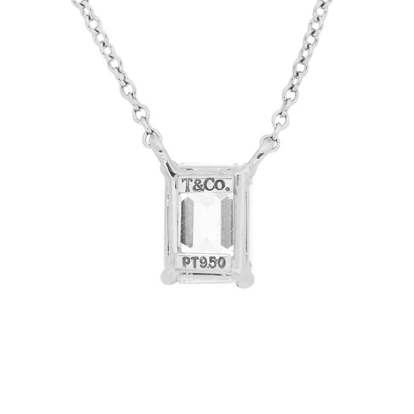 This wonderfully elegant, and simple pendant is pure perfection by Tiffany & Co. The Emerald cut diamond weighs exactly 1.00 carat, and has been graded as F in colour and VS2 in clarity. It is expertly set within a four-claw collet, and the platinum