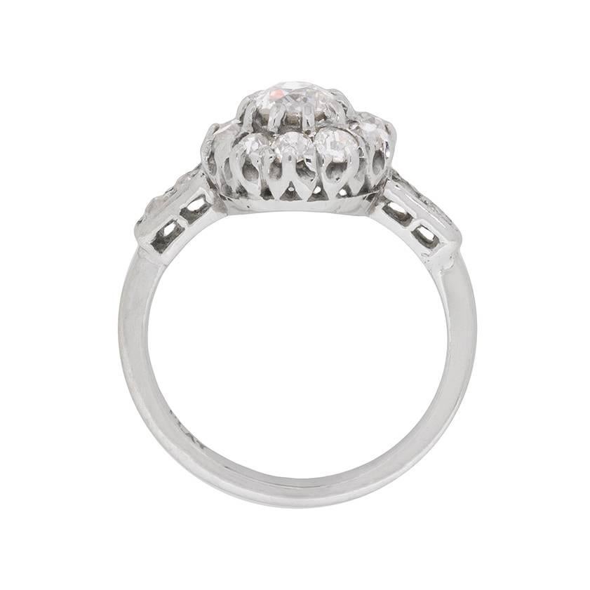 This art deco cluster ring, made entirely of platinum, boasts a centre stone of 0.65 carats. This is then haloed by another 10 diamonds, just as dazzling, within the claw setting. To finish off the diamond collection, there are 2 little old cuts