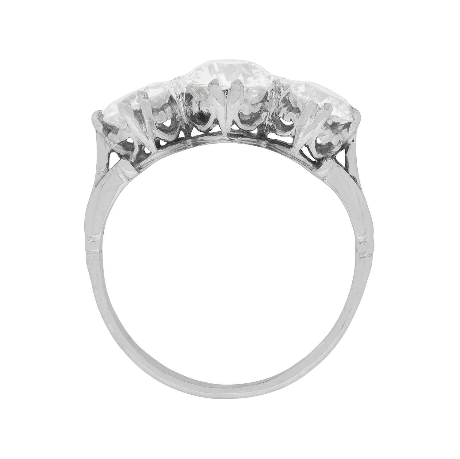 This absolutely stunning three stone ring features a centre stone of 1.50 carat, supported on either adjacent side by 1.00 carat diamonds. The stones are sparkling old cuts, which have been estimated F to G in colour and VS in clarity. They are