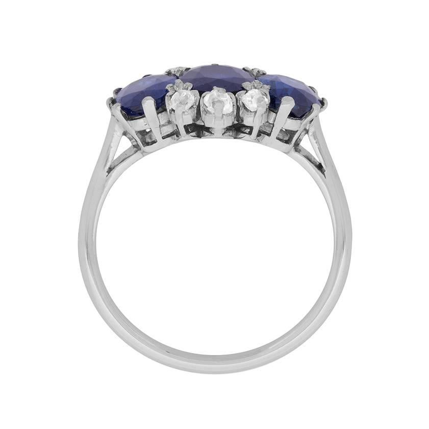 This original and stunning Sapphire ring features three oval shaped sapphires which are a rich, deep blue, set alongside one another. The centre sapphire is 1.50 carat, whilst the two on either side each weigh 1.25 carat, bringing the total gemstone