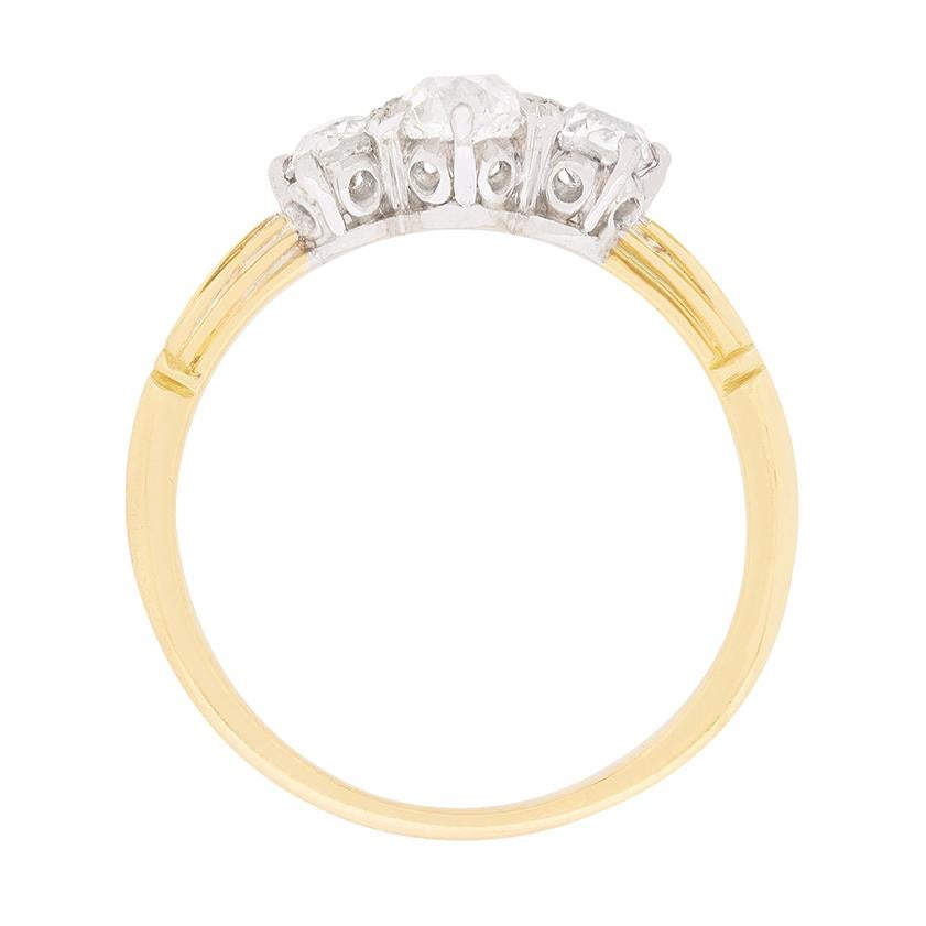 This delicate three stone engagement ring features old cut diamonds dating back to the 1900s. The centre diamond weighs 0.40 carat and the two set adjacent weigh 0.25 carat each. This brings the total weight to 0.90 carat and they are set within