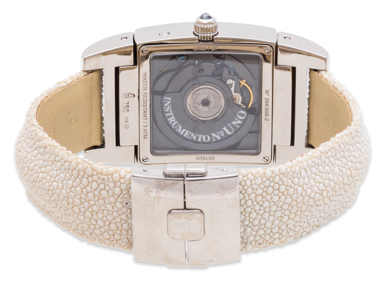 De Grisogono Instrumento UNO 18K White Gold Ladies Watch with two row Factory Diamond Bezel on Ivory Galusha Strap. Ref. UNO DF With Box & Papers, Case size 32.5 x 55mm.