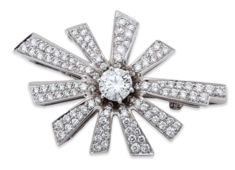 Chanel Diamond Brooch / Pendant in 18KWG. Center stone 1.00ct E/ VS GIA Certified Diamond, surrounded by diamond pave rays. Can be worn as a pendant or as a brooch.
U.S. Retail Price: $52,000