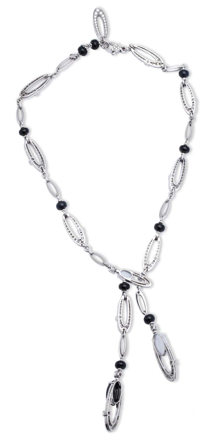 Authentic BVLGARI Elisia necklace with Diamonds, Onyx, and Chalcedony in 18K White Gold. Necklace consists of various size and design white gold diamond links, separated by onyx rondells. Bottom links with onyx and chalcedony. Trademark 