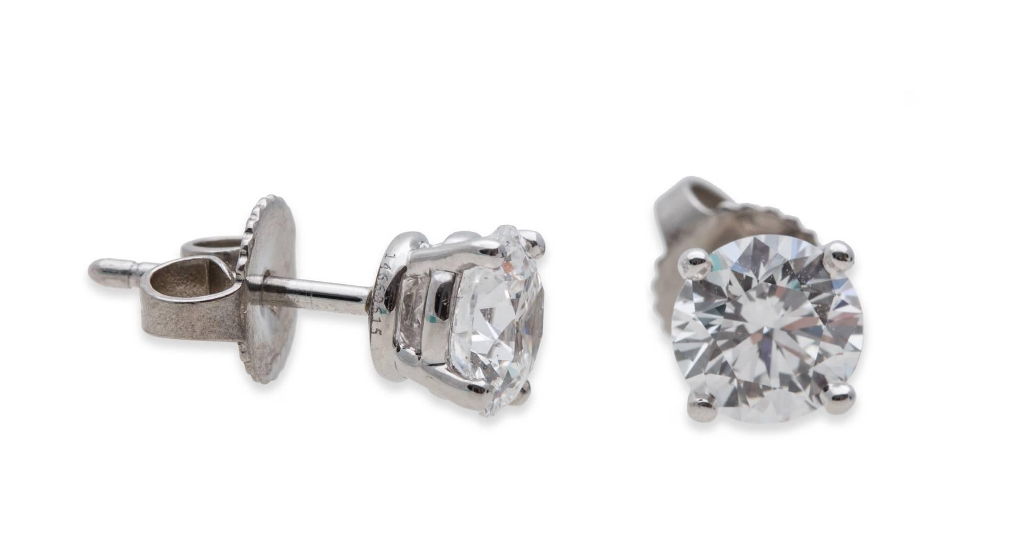 Tiffany & Co. Round Diamond Stud Earrings in Platinum. 0.72 ct E VS1 and 0.74 ct E VS1, Total Diamond Weight: 1.46 ct, Signed: 