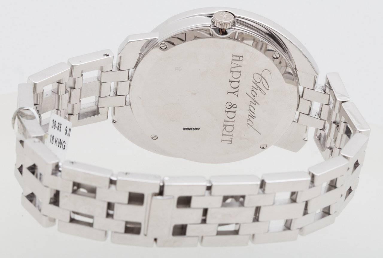 Chopard Happy Spirit Ladies watch in 18K White Gold, White Mother of Pearl Dial, Case Size: 32mm, Full Diamond Bezel, (2) Free Floating Diamond Circles & (1) Free Floating Bezel Mounted Round Diamond under the crystal, 18K White Gold Bracelet,
