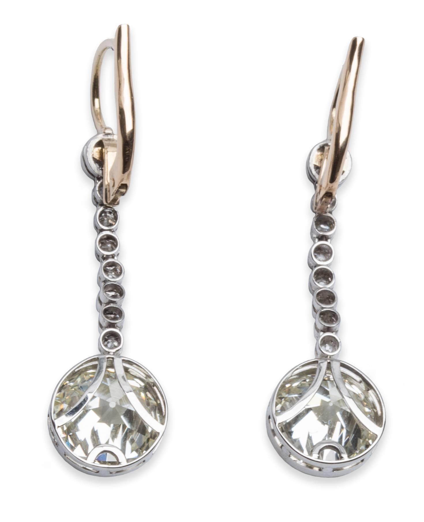 Old European Cut Diamond Earrings in 18K Rose Gold and Platinum. 5.90 carat Total Diamond Weight for both main diamonds, each stone is approximately 2.95 carat. The Earrings are 1.75 inches long.