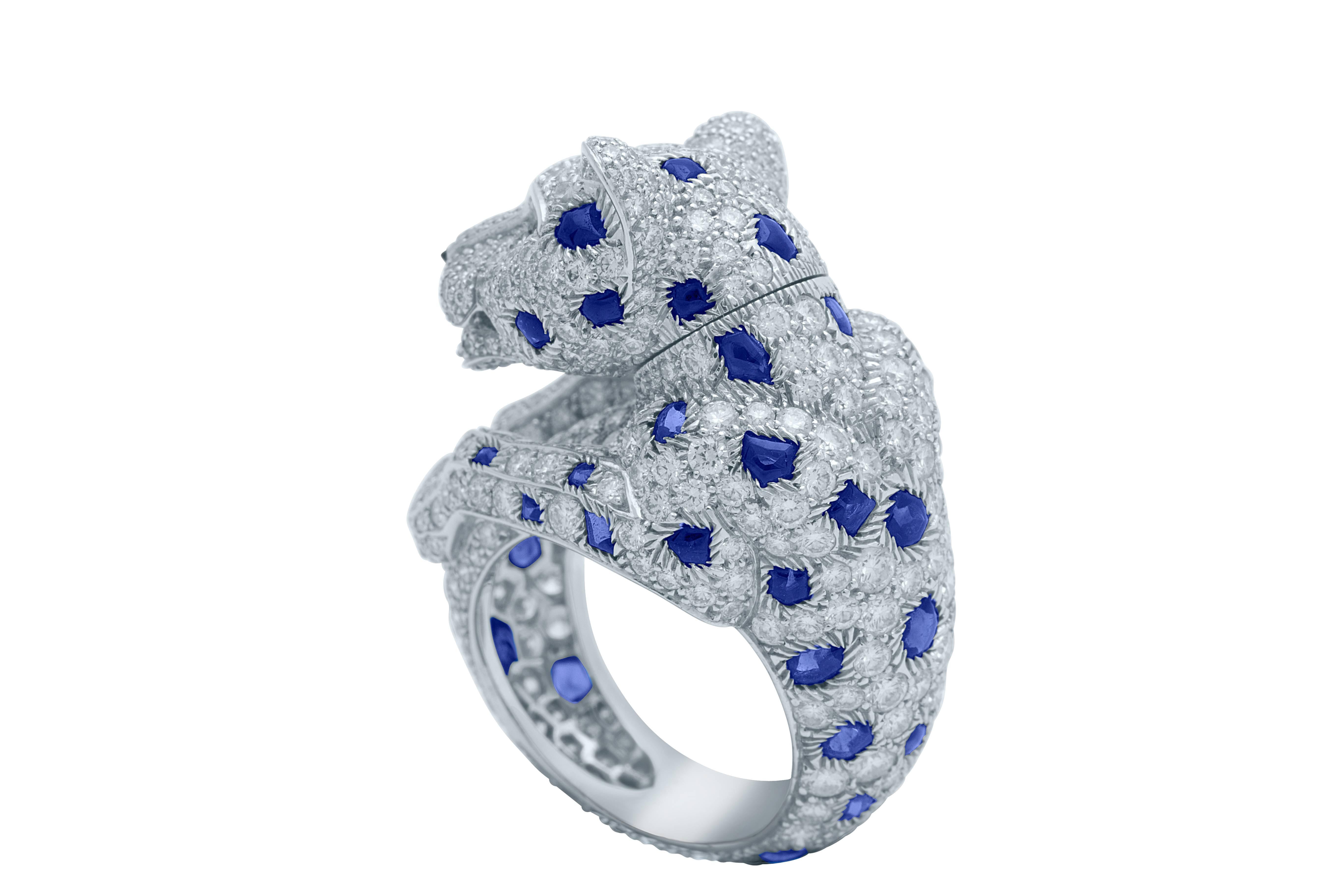 Cartier Panther de Cartier Ring in Platinum with Blue Sapphires, Emerald Eyes, Onyx, and Brilliant-Cut Diamonds.
The Panthers Head can be turned from side to side. Diamond Weight: 5.45ct, Sapphire Weight: 4.23ct, Emerald Weight: 0.12ct, Size: 5.25